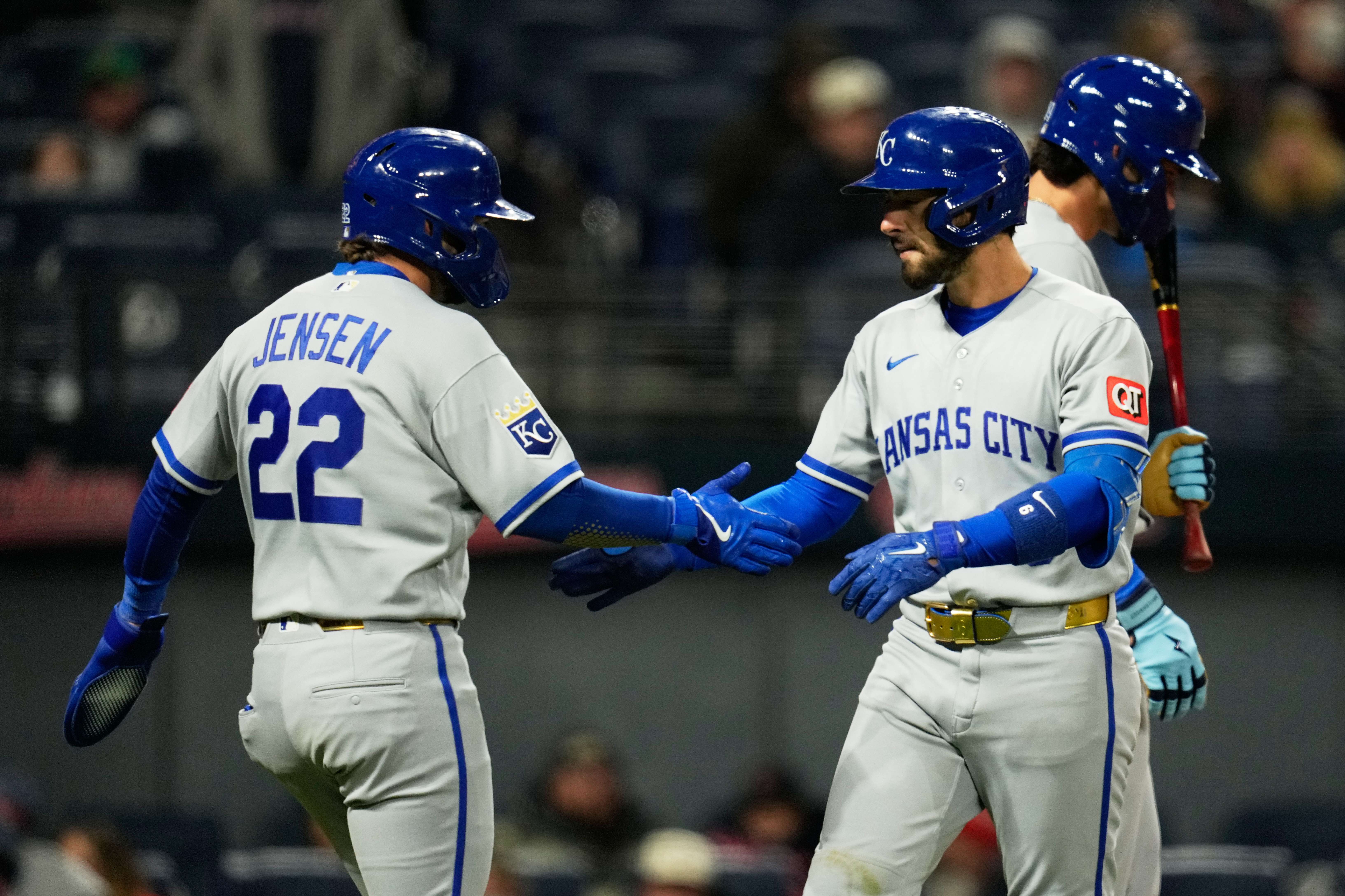 Kansas City Royals' Jonathan India, right, celebrates with teammate Carter Jensen (22) after both scores on India's two-run home run in the eighth inning of a baseball game against the Cleveland Guardians in Cleveland, Monday, April 6, 2026. (AP Photo/Sue Ogrocki)