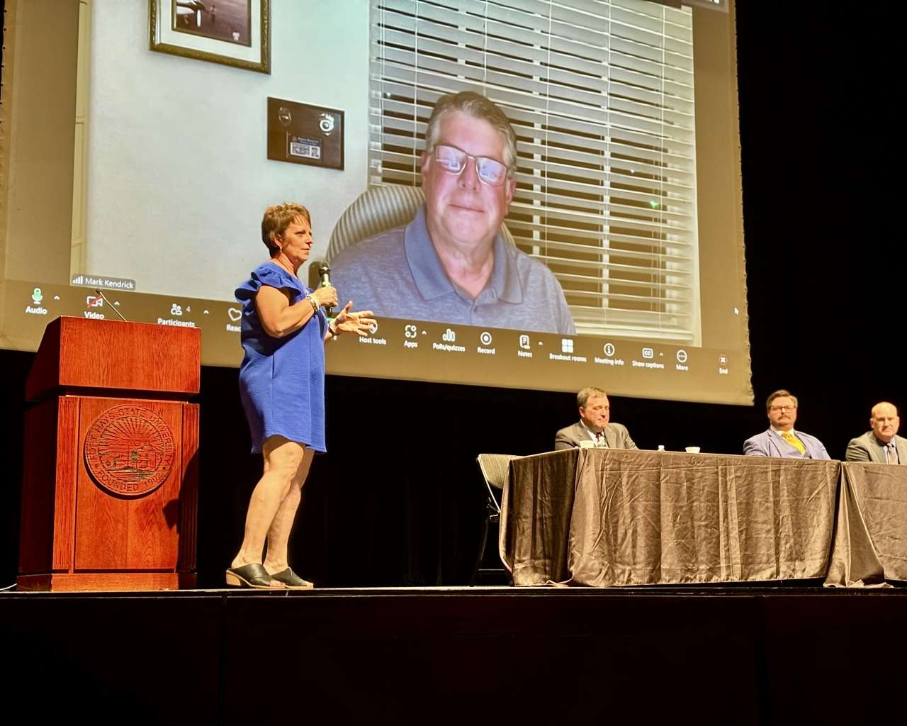 Stacie Edgett-Minson speaking on stage at Fort Hays State University's Beach Schmidt Auditorium about her experience surviving the I-70 rapist with a panel of law enforcement. Photo by Tony Guerrero/Hays Post