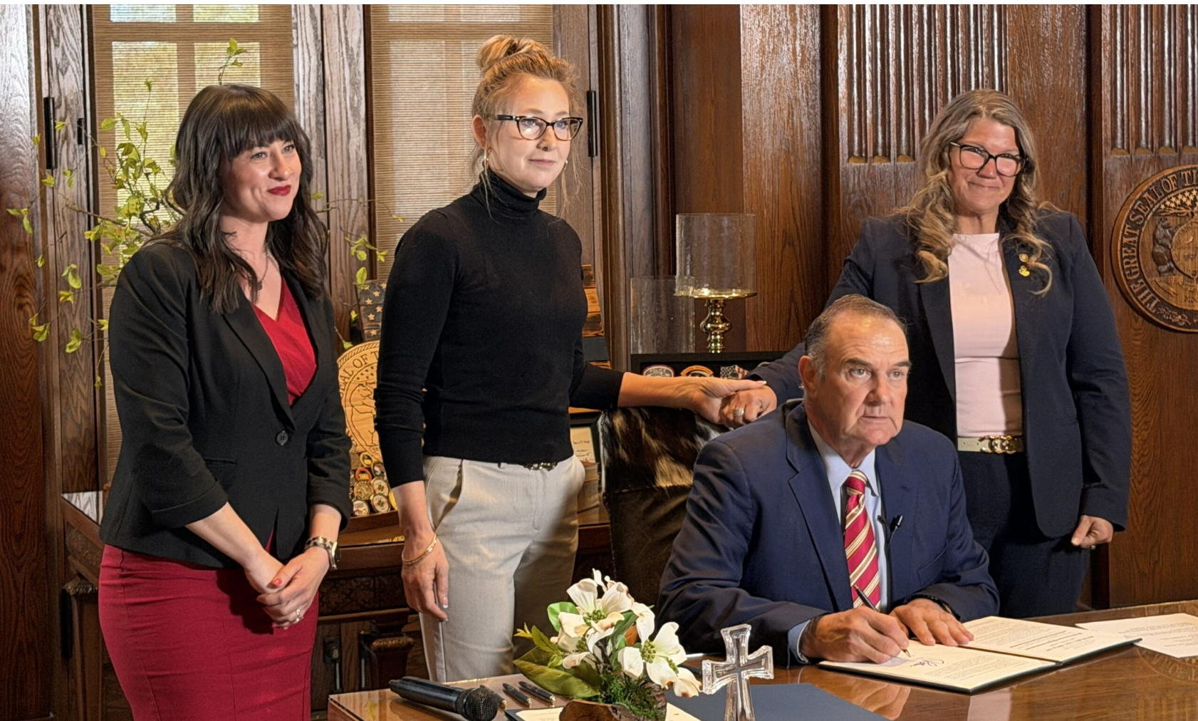 House Minority Leader Ashley Aune, state Sen. Jill Carter, Gov. Mike Kehoe, state Rep. Cecelie Williams and state Rep Raychel Proudie (not pictured) pose for a photo after Kehoe signed a bill clarifying the right to divorce while pregnant on Tuesday (Steph Quinn/Missouri Independent).