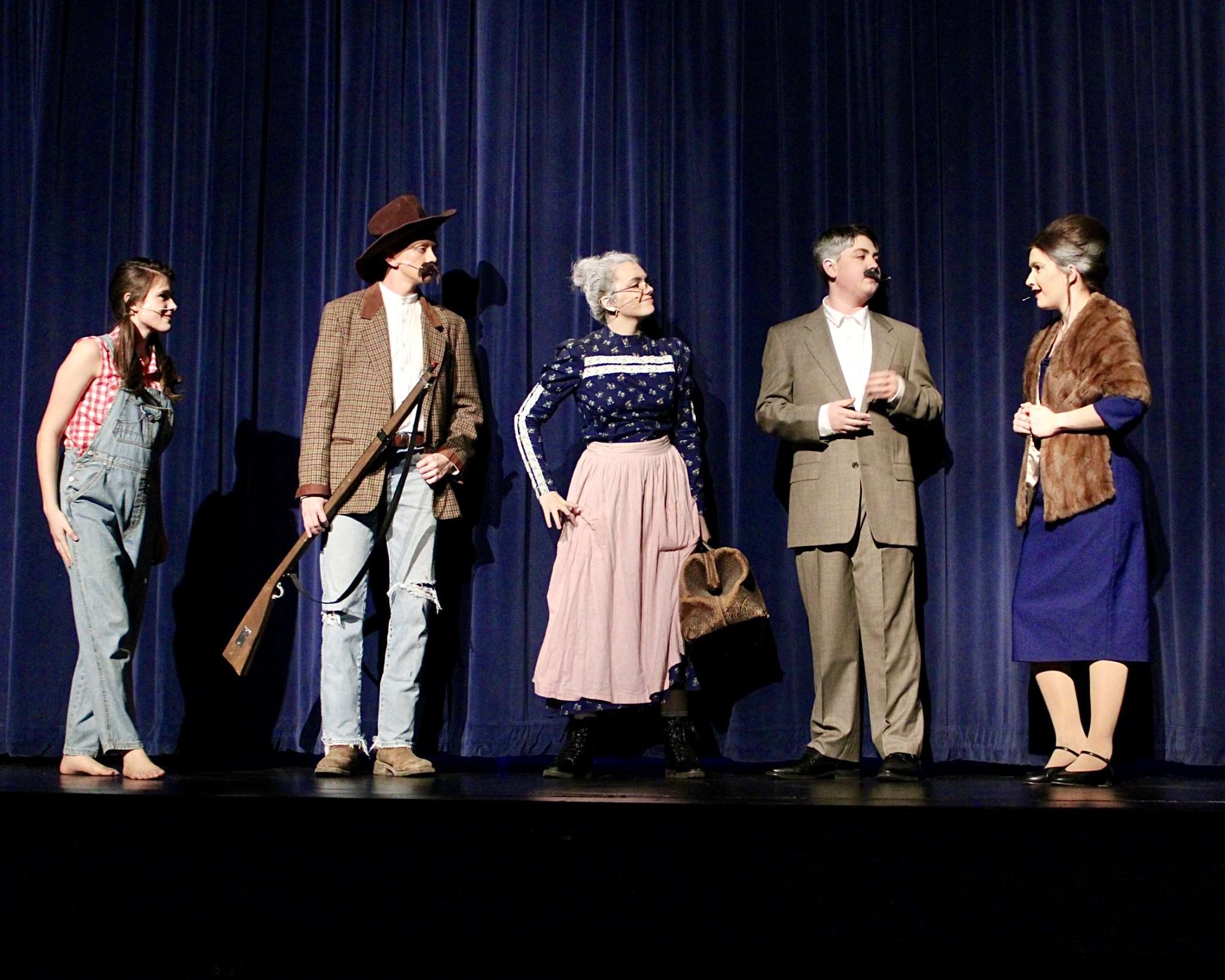 (Left to right) Grace Schmeidler as Elly May Clampett, Blaise Staab as Jed Clampett, Morgan Greenwood as Granny, Jack Stoecklein as Mr. Drysdale and Alyssa Church as Mrs. Drysdale taking center stage for Thomas More Prep-Marian's "The Beverly Hillbillies" production. Photo by Tony Guerrero/Hays Post