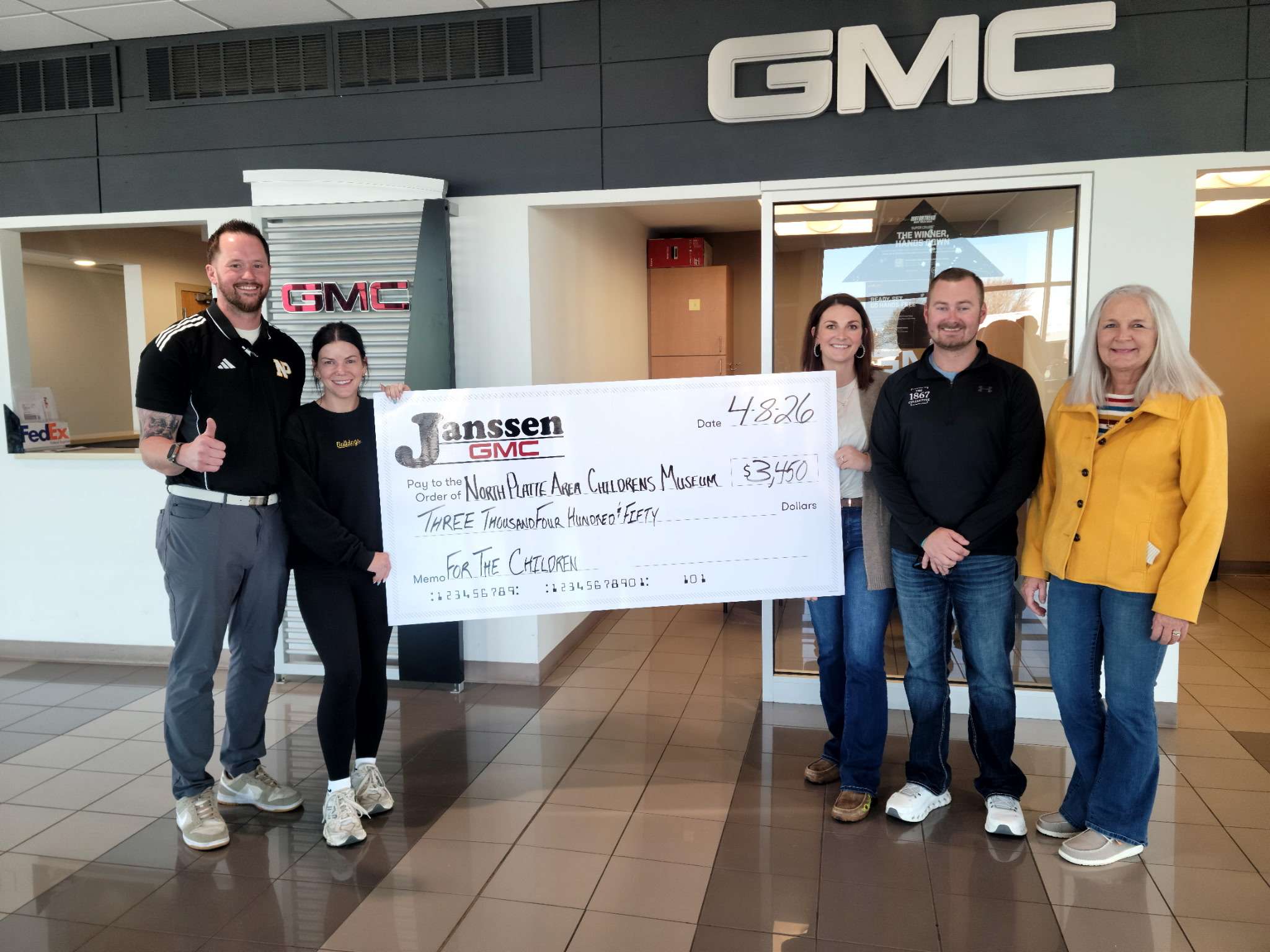 Janssen GMC in North Platte donates $3,450 to the North Platte Children's Museum after setting aside $50 from vehicle purchases.