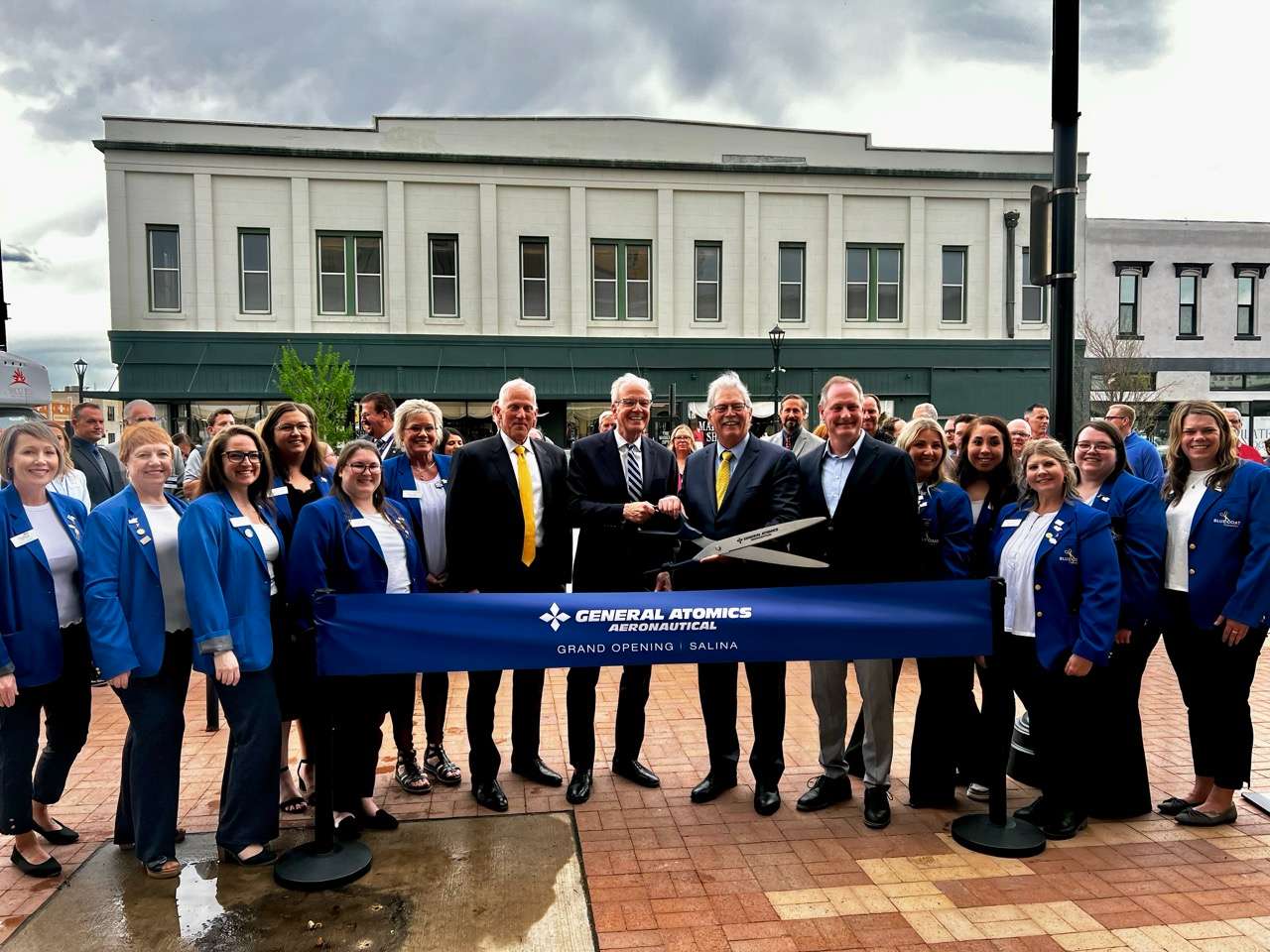 U.S. Senator Jerry Moran (R-Kan.), U.S. Representative Tracey Mann (R-Kan.), General Atomics staff and blue coats of the Salina Area Chamber of Commerce celebrate ribbon cutting of the defense and technology company's office in Salina on April 9, 2026 - Photo, Nicolas Fierro