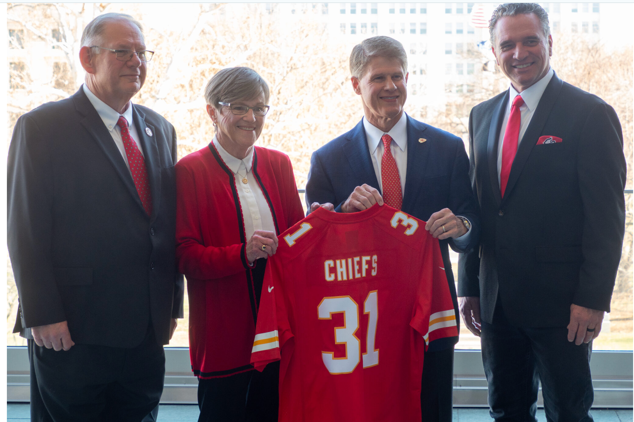 Gov. Laura Kelly and the Kansas Legislature are reading from the same playbook for development of a Kansas sports authority to guide a public-private partnership for construction of a domed stadium in Wyandotte County for the Kansas City Chiefs and construction of a team headquarters and practice facility in Johnson County. This Dec. 22, 2025, image shows, from left, House Speaker Dan Hawkins, Kelly, Chiefs Owner Clark Hunt and Senate President Ty Masterson. (Photo by Anna Kaminski/Kansas Reflector)
