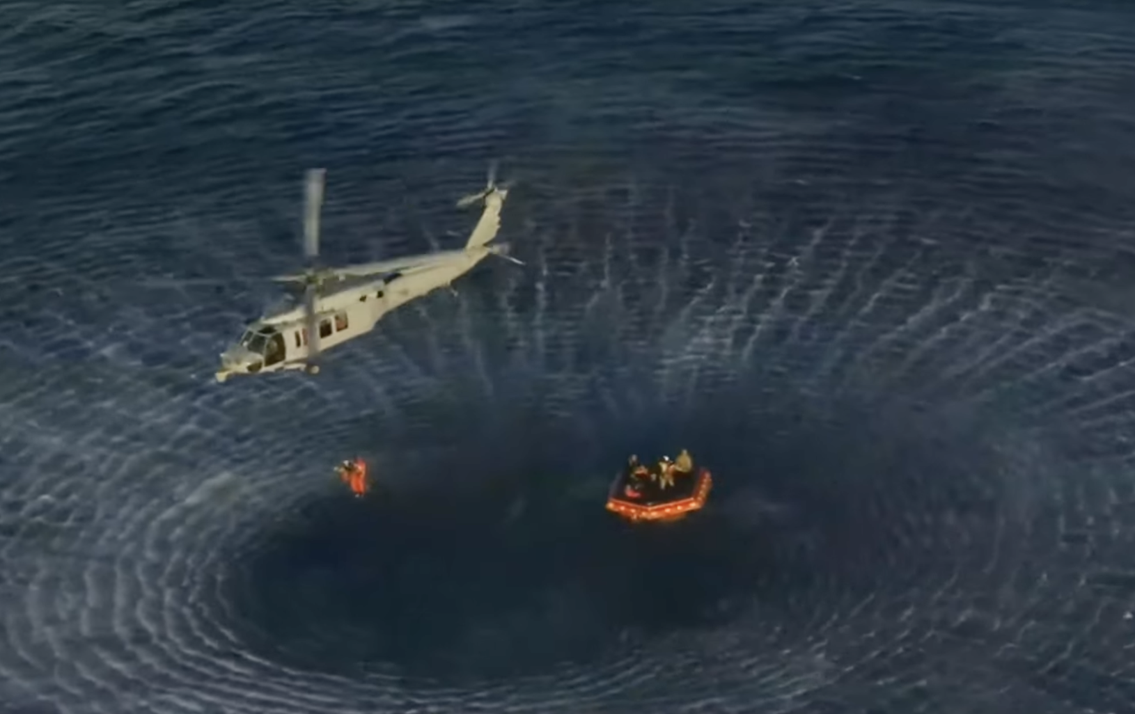 Astronauts lifted by the recovery helicopter to the Navy ship-image from NASA video