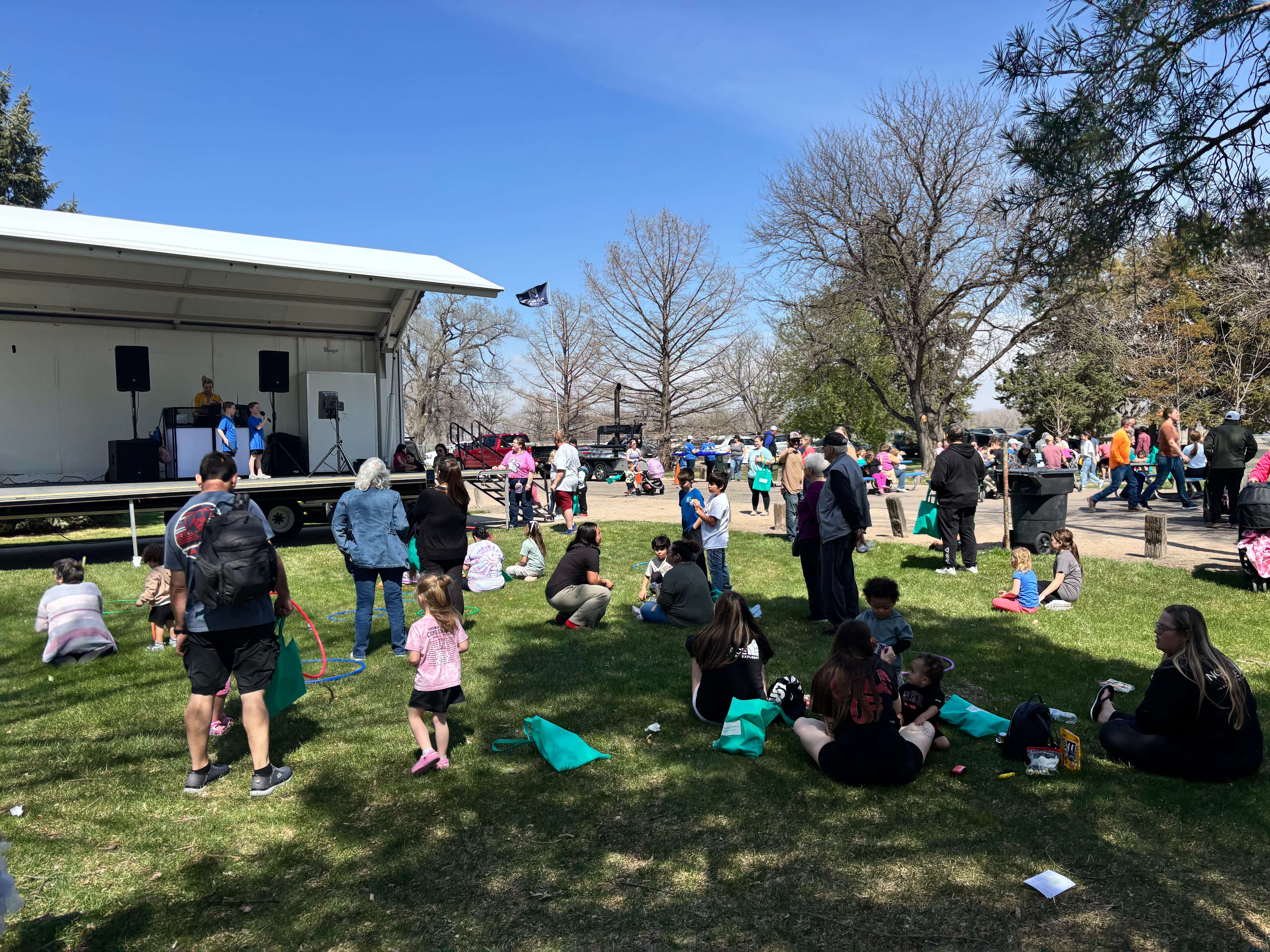 Families gather near the stage during Kids in the Park on April 11 at Cody Park, Where karaoke performances kept kids entertained throughout the afternoon. (The Post)