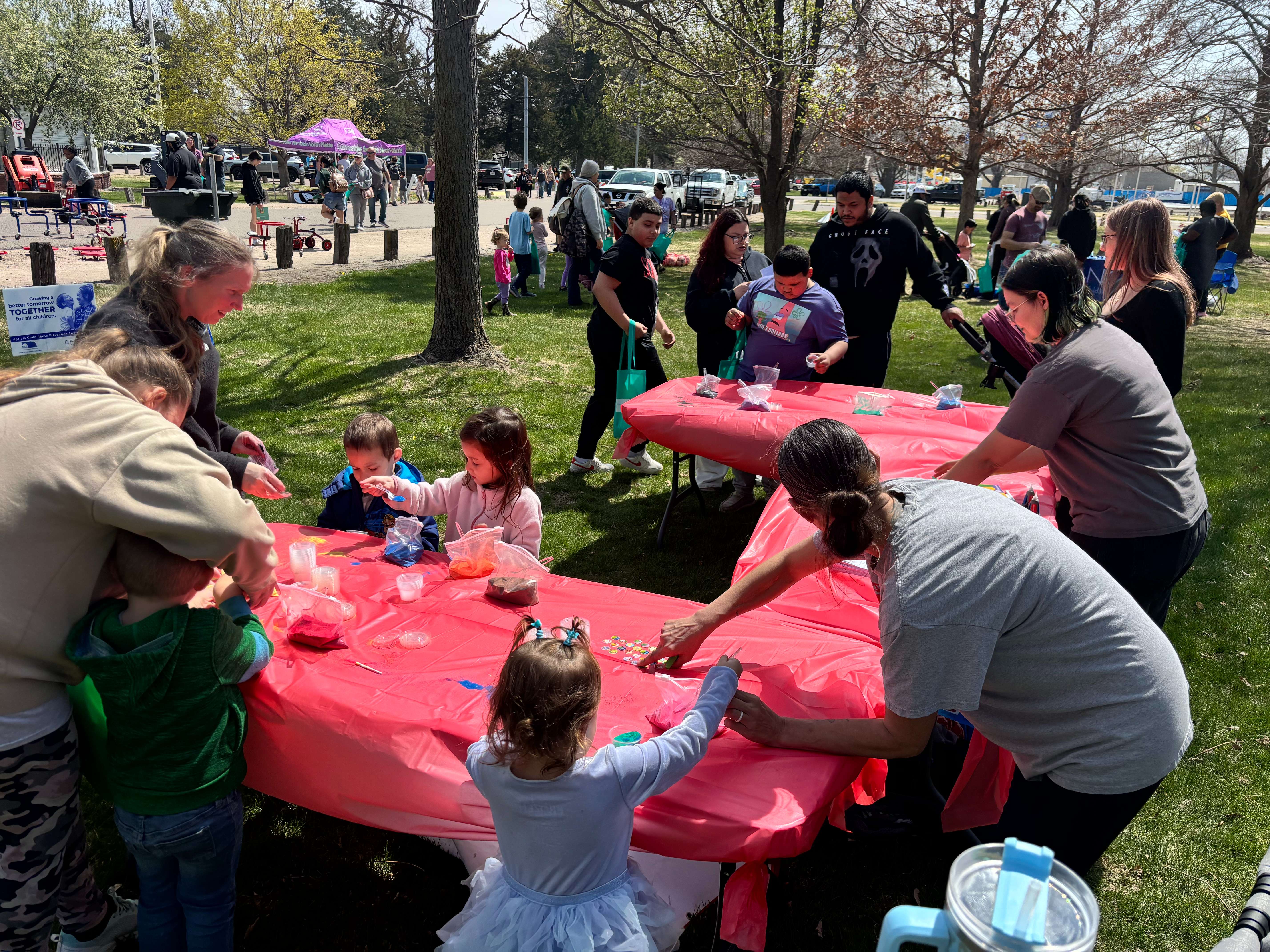 Kids create colorful sandart at the Trucks N Tiaras booth, one of the popular hands-on activities at this years event. (The Post)