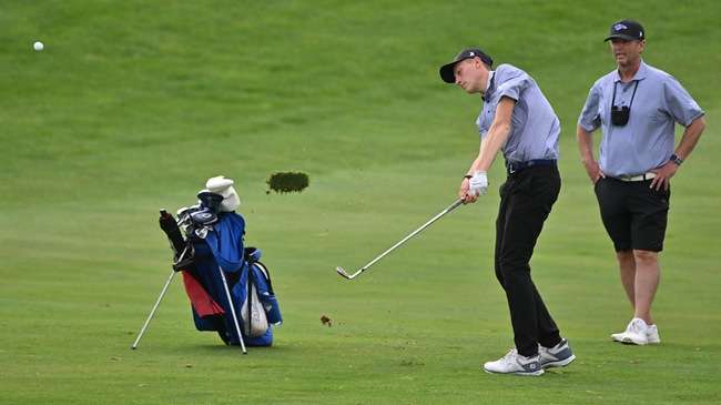 Blue Dragon freshman Hugo Duqauine chips onto the 11th green during his opening-round 68 on Sunday at the KJCCC Men's Golf Championship at Sand Creek Station in Newton. (Andrew Carpenter/Digital Fox Photography)