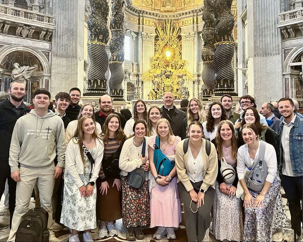 Fort Hays State University Catholic Tigers with Bishop Gerald Vincke of the Salina Diocese in front of the St. Peter's Basilica altar in Rome. Courtesy photo
