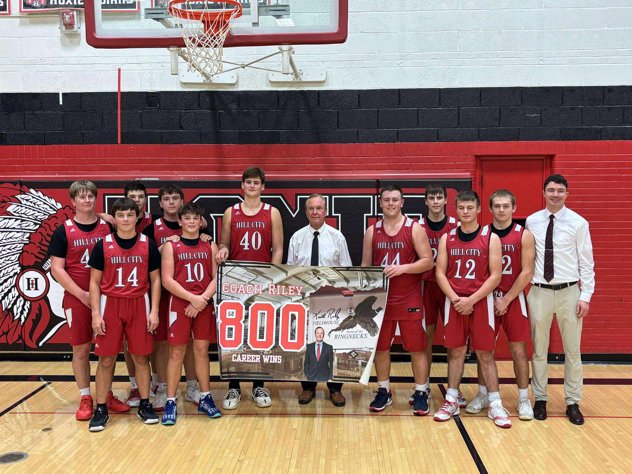 Hill City basketball coach Keith Riley and his team following his 800th coaching win on December 19, 2025 in Hoxie, Kan. (Photo courtesy Kansas Pregame)