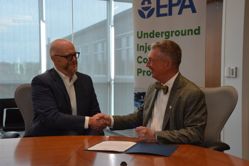 EPA Region 7 Administrator Jim Macy signs a letter authorizing carbon dioxide injection under Kansas’ first Class VI well permit during a meeting with PureField Carbon Capture Chief Executive Officer Aaron Buettner on April 10. Photo by U.S. EPA