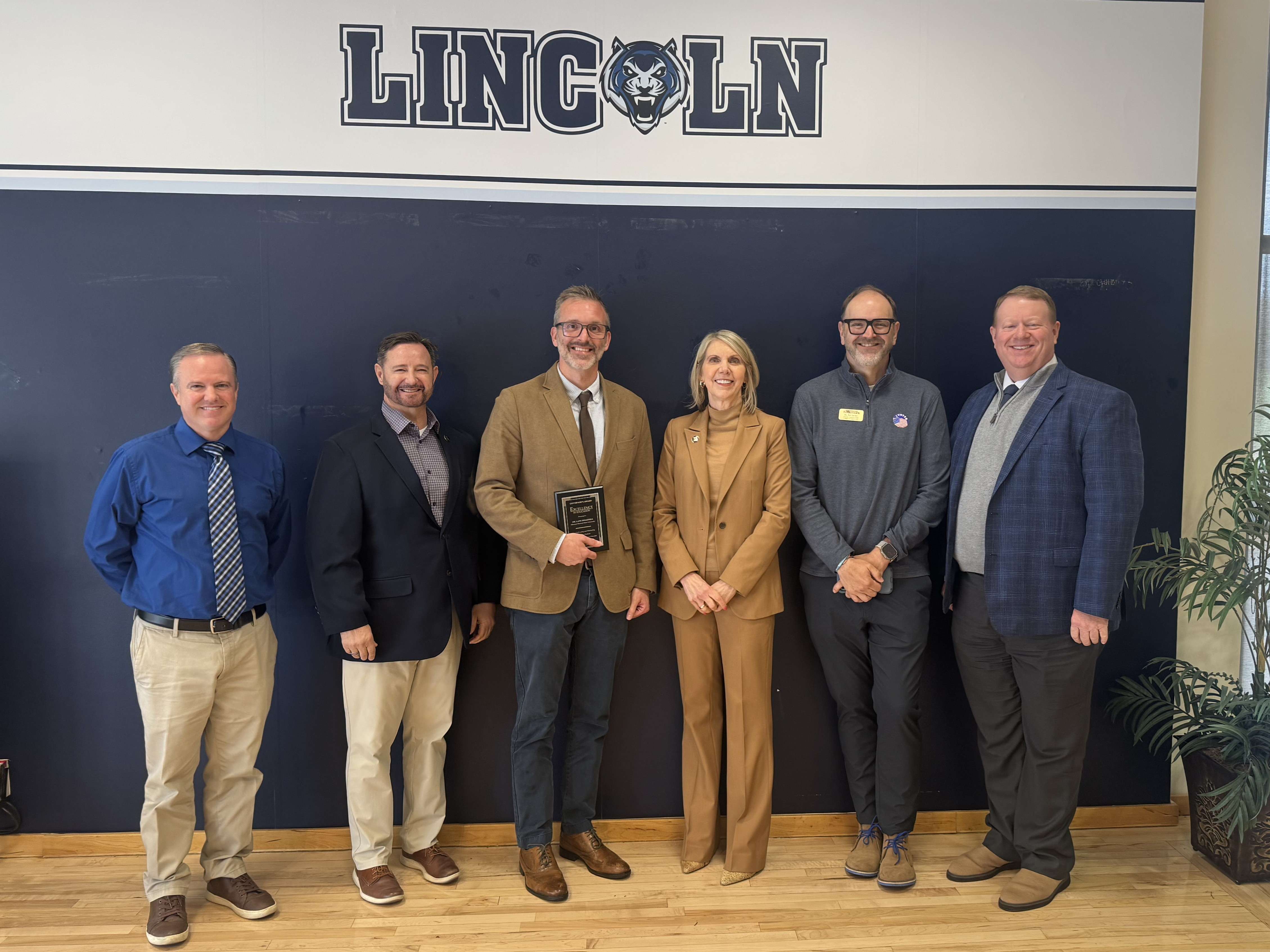Dr. DesAutels is congratulated by Dr. Kennedy and other MoWest officials at the COPHE luncheon/ Photo courtesy of MoWest Communications&nbsp;