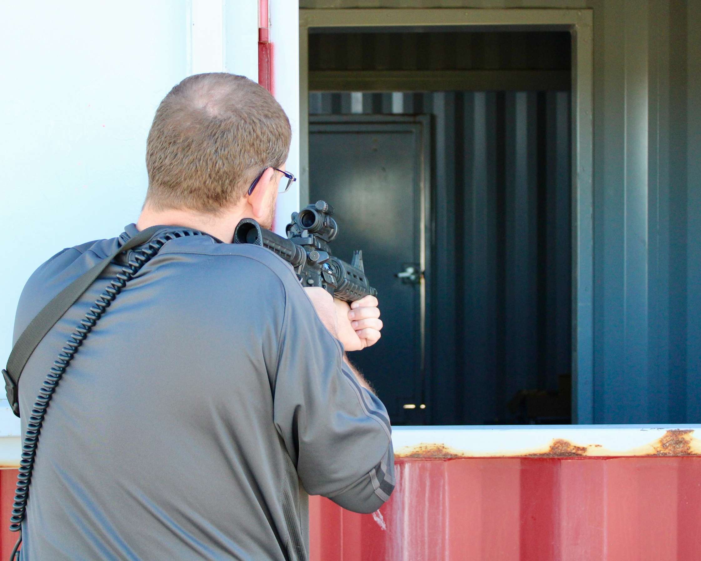 A Hays officer with his firearm drawn at a window.&nbsp;Photo by Tony Guerrero/Hays Post