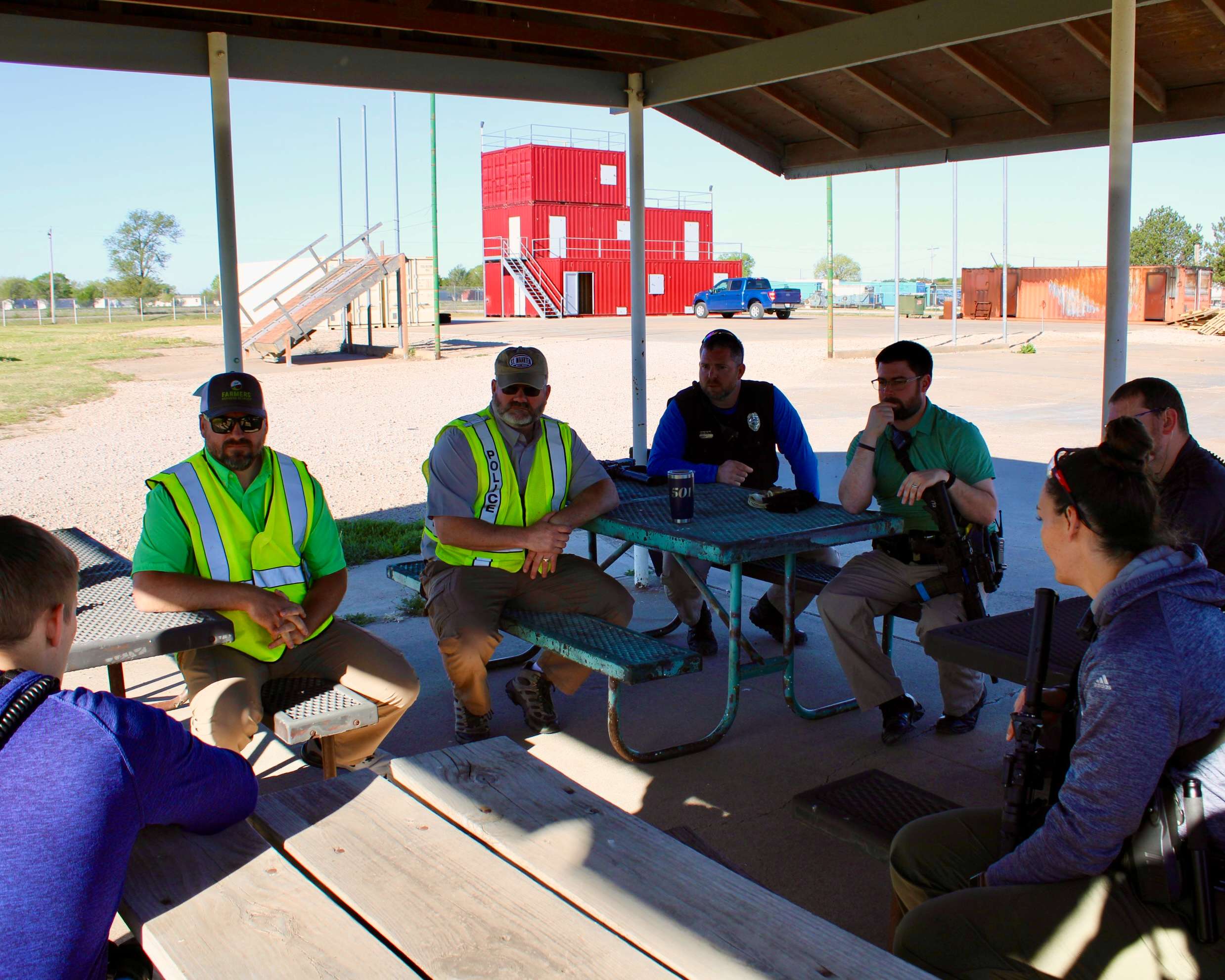 Instructors and Hays police officers, after a critical incident response training session, debrief on their performance. Photo by Tony Guerrero/Hays Post