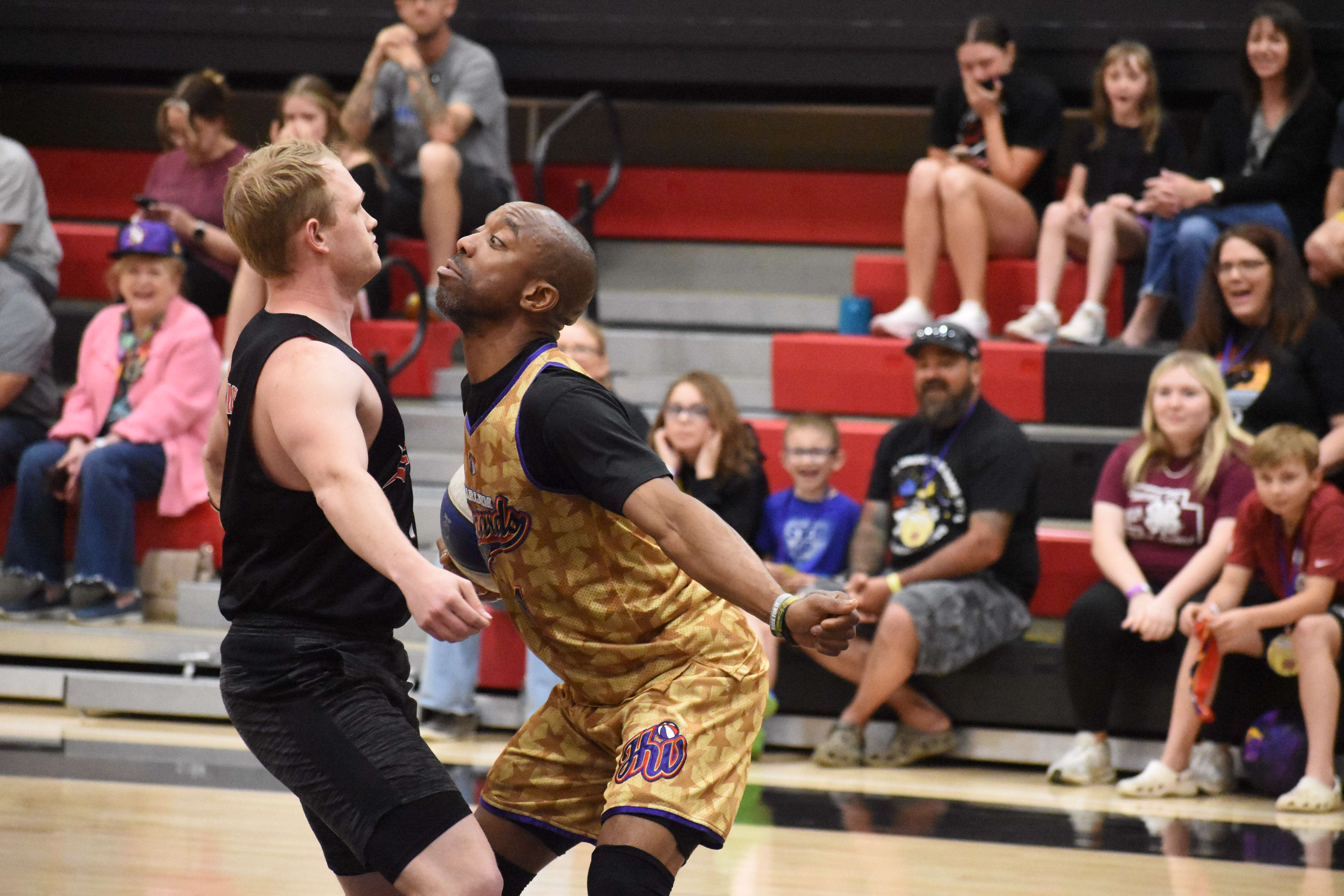 Firefighter Hasket shows off some dance moves against a Wizards player.