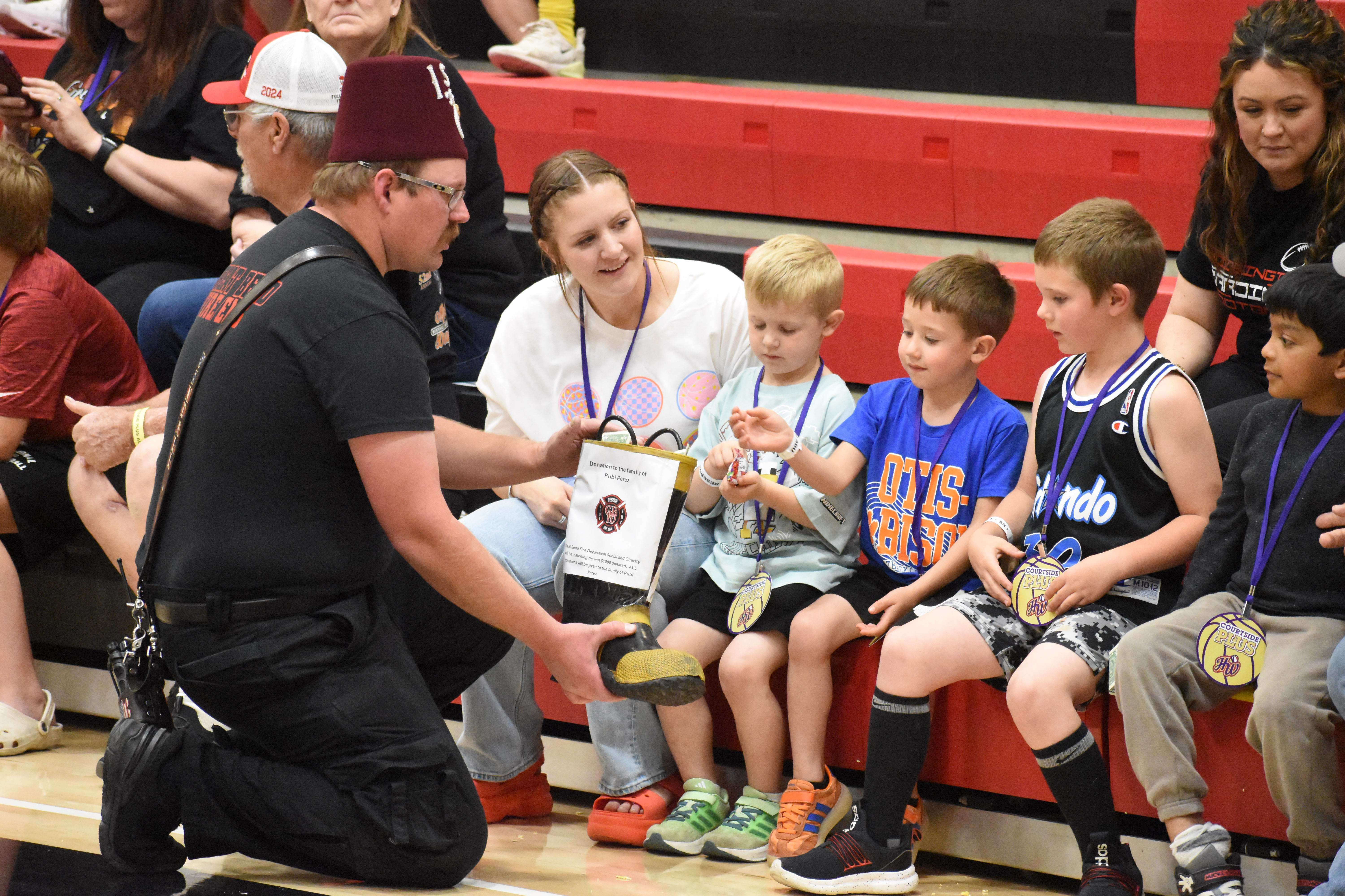 Great Bend firefighters "passed the boot" to collect donations during Thursday's exhibition basketball game with the Harlem Wizards at Great Bend High School.
