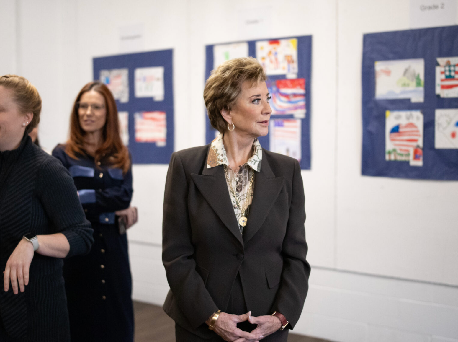  U.S. Education Secretary Linda McMahon takes in a selection of grade school students’ patriotic artworks and high schoolers’ recent output in a special installation set up at Exeter-West Greenwich Regional Junior High and High School in Rhode Island on Monday, Jan. 12, 2026. (Photo by Alexander Castro/Rhode Island Current)