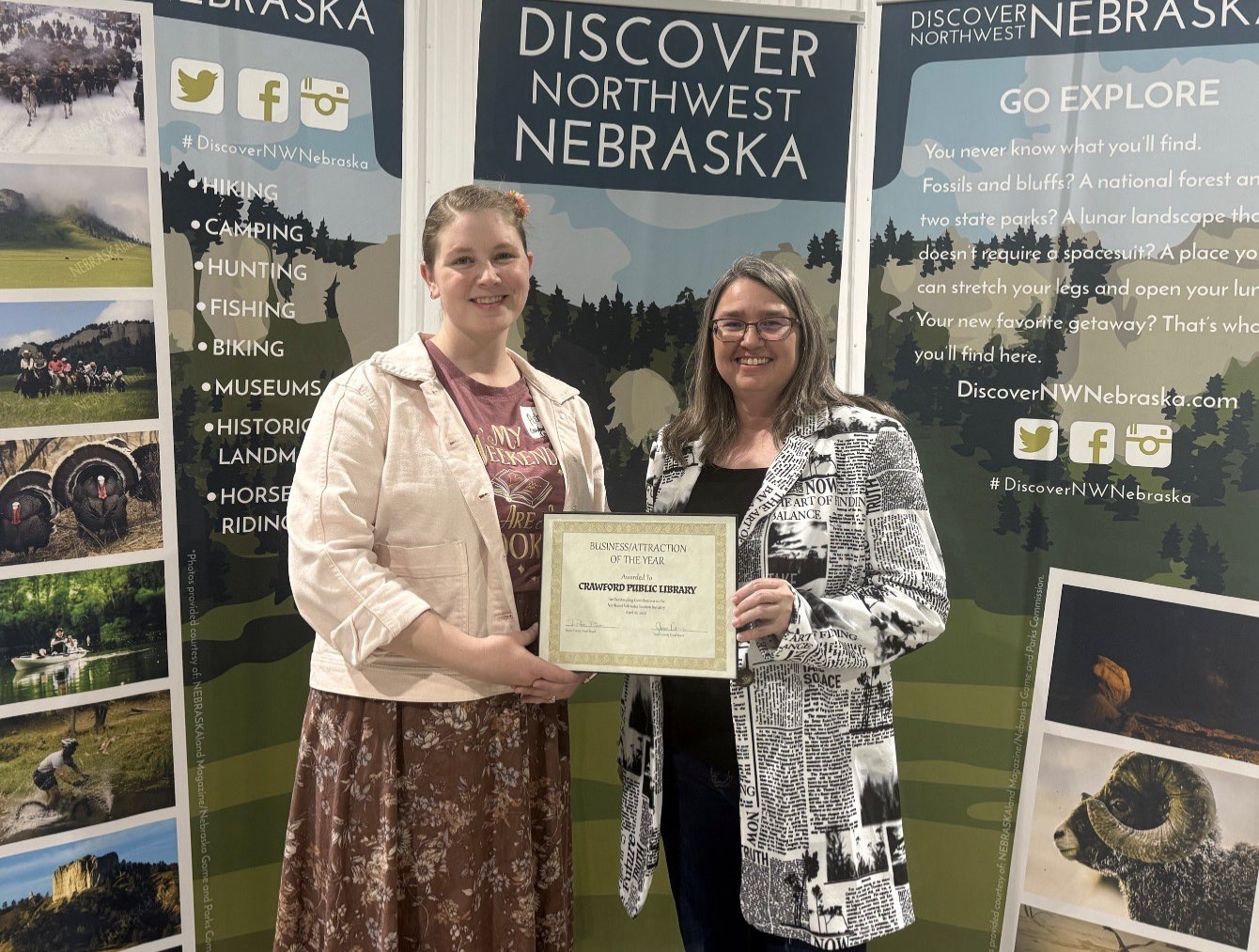 Discover Northwest Nebraska Director Kerri Rempp, right, presents Ashy Blacksheep, left, with the Business/Attraction award for the Crawford Public Library April 16. Photo by Jess Espinoza/Crawford Clipper-Harrison Sun