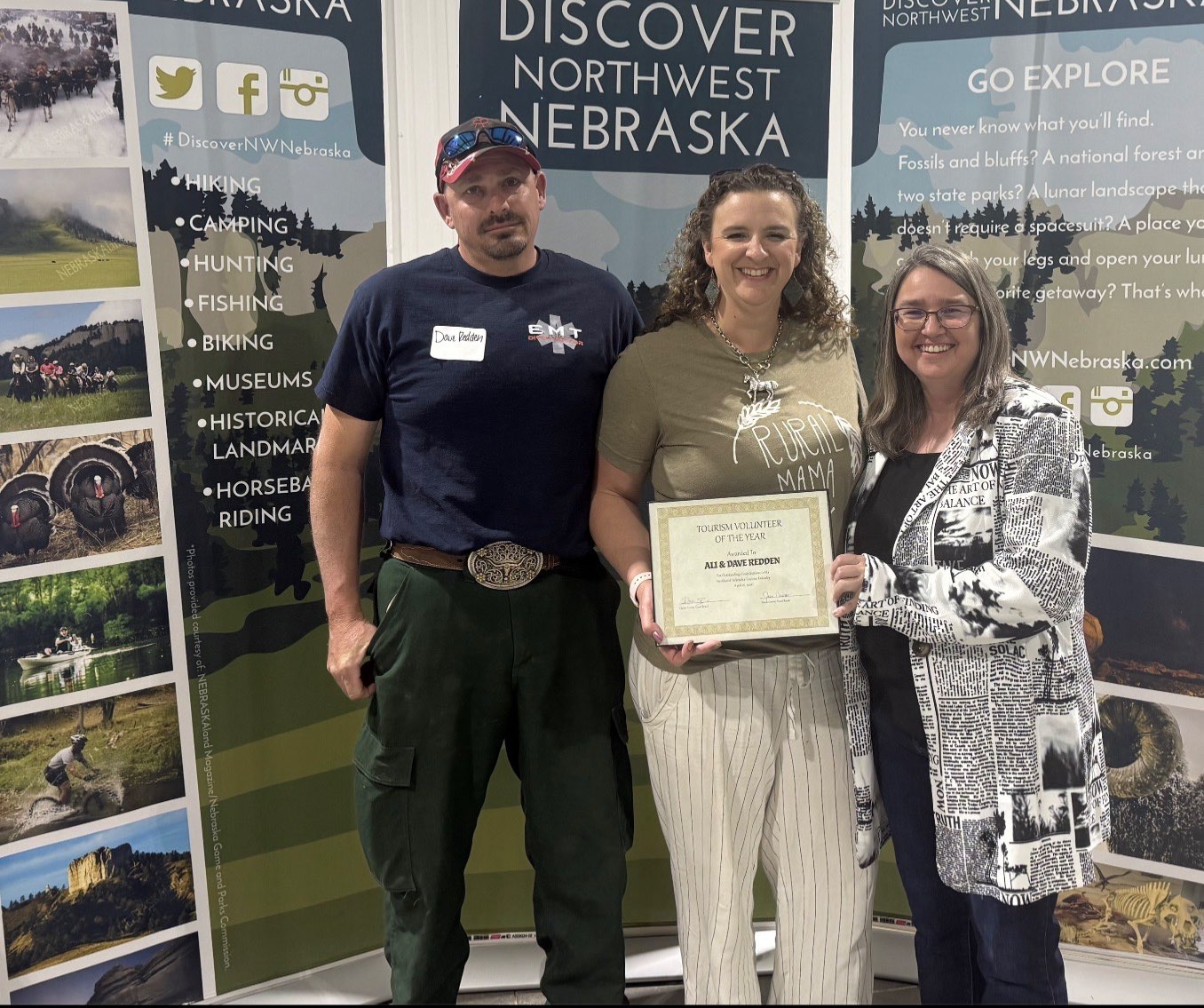 Discover Northwest Nebraska Director Kerri Rempp, right, presents Dave and Ali Redden, left and center, with the Volunteer of the Year award April 16. Photo by Jess Espinoza/Crawford Clipper-Harrison Sun