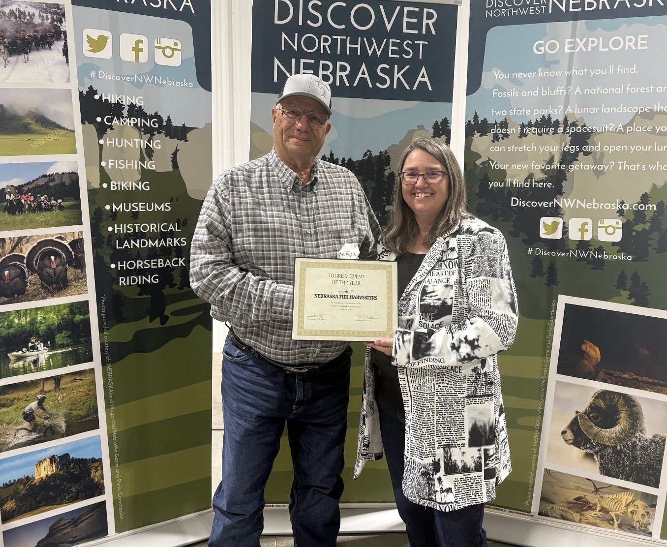 Discover Northwest Nebraska Director Kerri Rempp, right, presents Don Fryda, left, with the Event of the Year award for the Western Nebraska Sportsman’s Expo and Nebraska Fur Harvesters Convention April 16. Photo by Jess Espinoza/Crawford Clipper-Harrison Sun