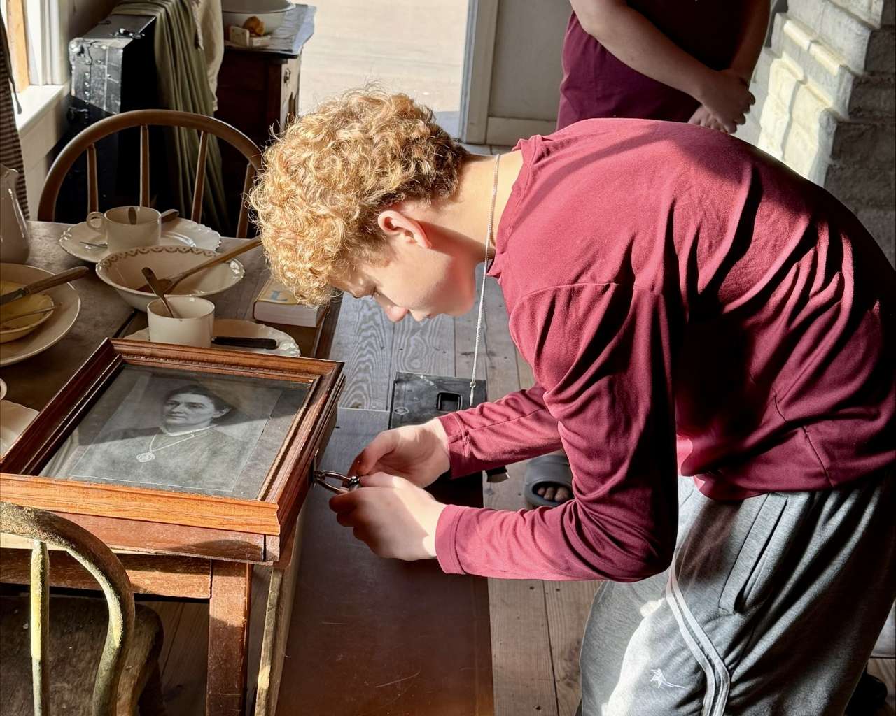 A Hays Middle School student working on a lock at the Ellis County Volga German Haus escape room as part of a test run. Courtesy photo