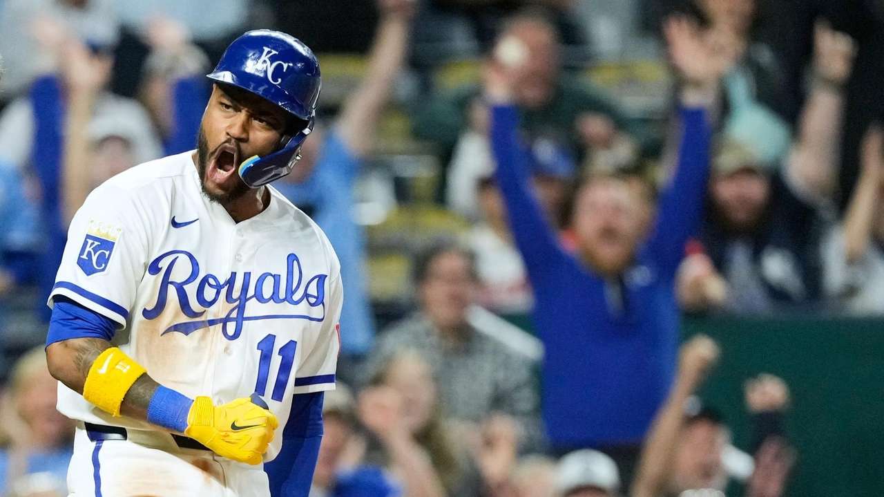 Kansas City Royals' Maikel Garcia celebrates after scoring the game-winning run on a wild pitch thrown by Baltimore Orioles relief pitcher Ryan Helsley during the ninth inning of a baseball game Tuesday, April 21, 2026, in Kansas City, Mo. (AP Photo/Charlie Riedel)