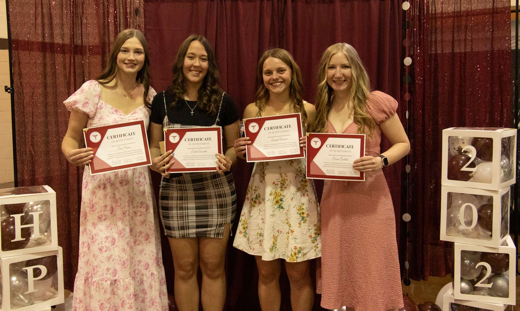 Chadron State College students advancing to UNMC in Dentistry pose at the Health Professions Club's Annual Banquet April 10, 2026, at the Assumption Arena. From left, Cora Payne of Utica, Neb., Carlie Schneider of Alliance, Neb., Shaylee Thomsen of Ord, Neb. and Emma Carfield of Trenton, Neb. (Photo by Tena L. Cook/Chadron State College)