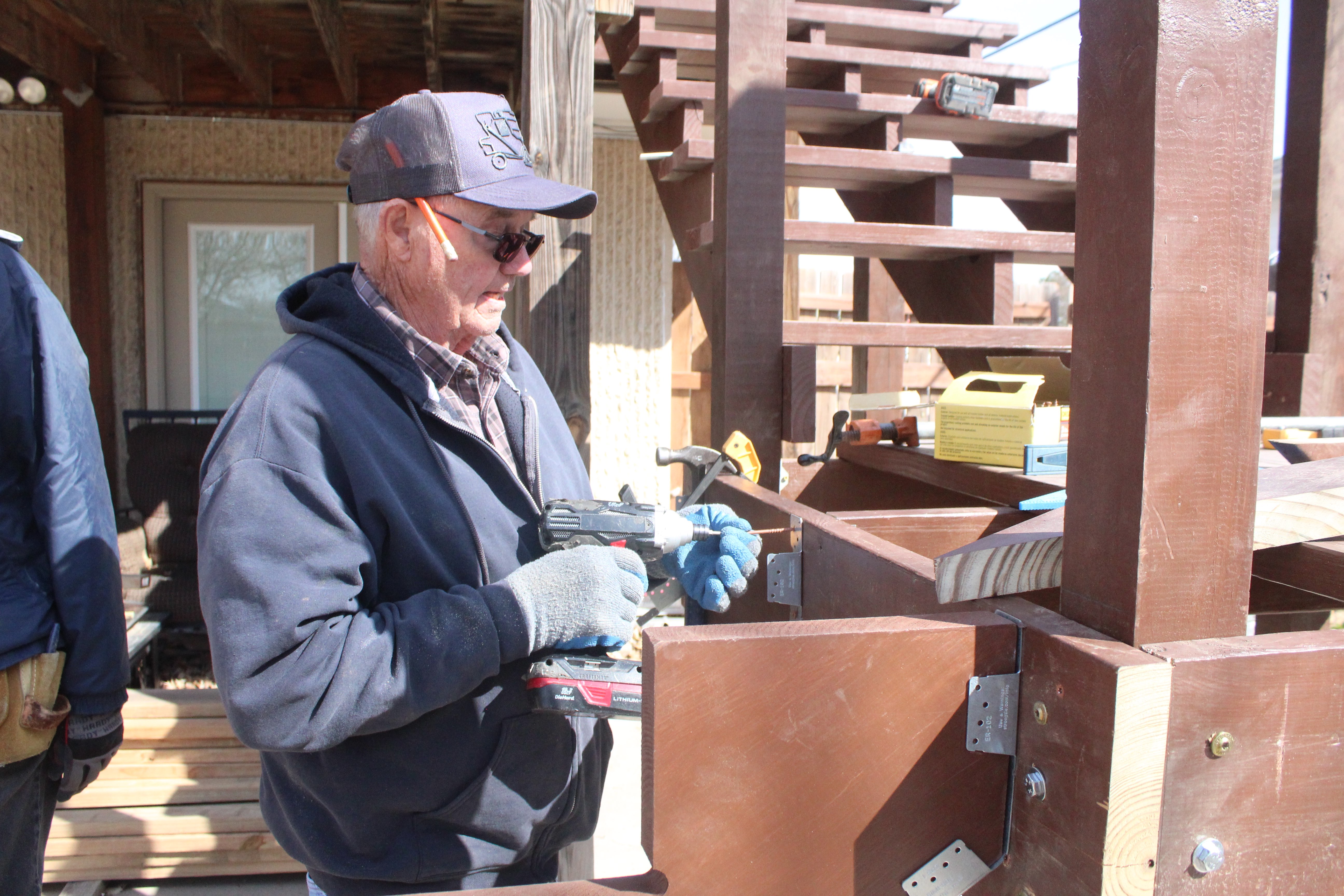 Ken Rohleder, volunteer, working on a Habitat stair repair project in March. Photo by Cristina Janney/Hays Post