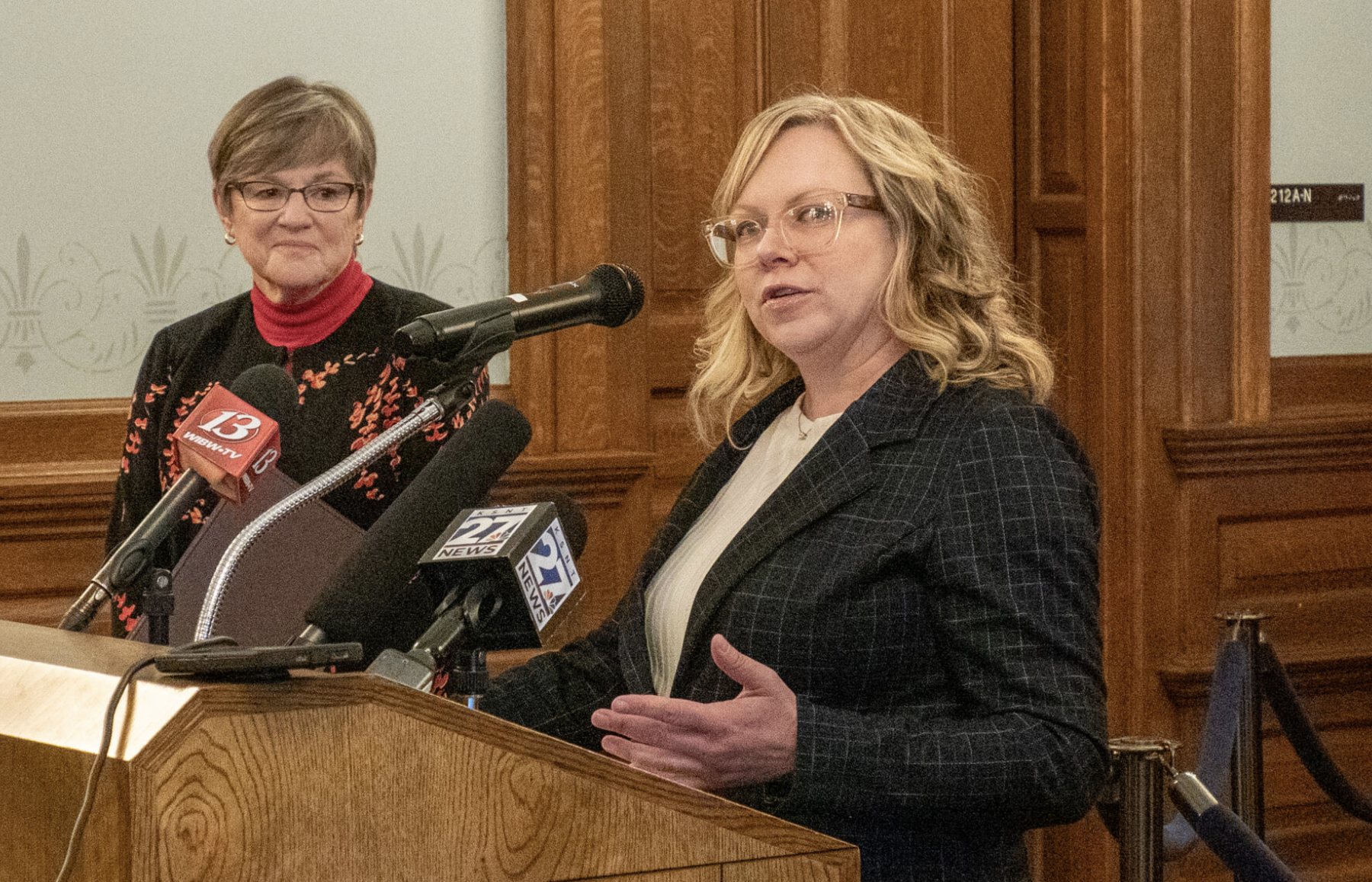  Kansas Gov. Laura Kelly, left, and Kansas Department of Labor secretary Amber Shultz announce the launch of the state's new online unemployment system Nov. 22, 2024, at the Statehouse in Topeka. Agency staff say the new system has allowed them to identify 8,526 overpayments made since Jan. 1, 2019. (Photo by Anna Kaminski/Kansas Reflector)