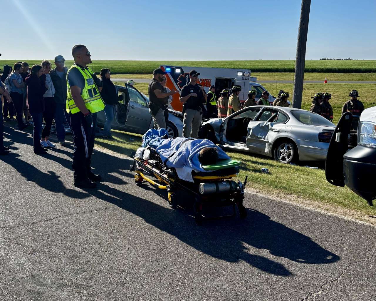 An actor on a stretcher under a blanket during a mock crash at Victoria High School after a simulated two-vehicle collision. Photo by Tony Guerrero/Hays Post