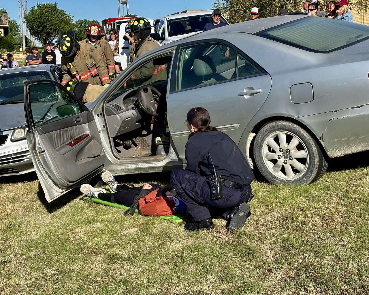 An injured driver on the ground from the mock crash at Victoria High School. Photo by Tony Guerrero/Hays Post