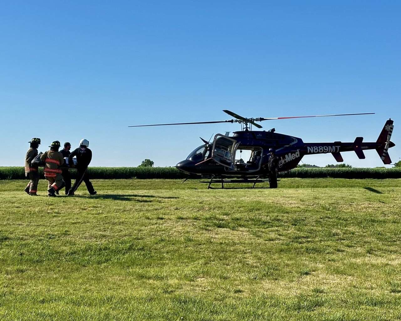 First responders taking the injured driver of the mock crash to an EagleMed helicopter to be airlifted. Photo by Tony Guerrero/Hays Post