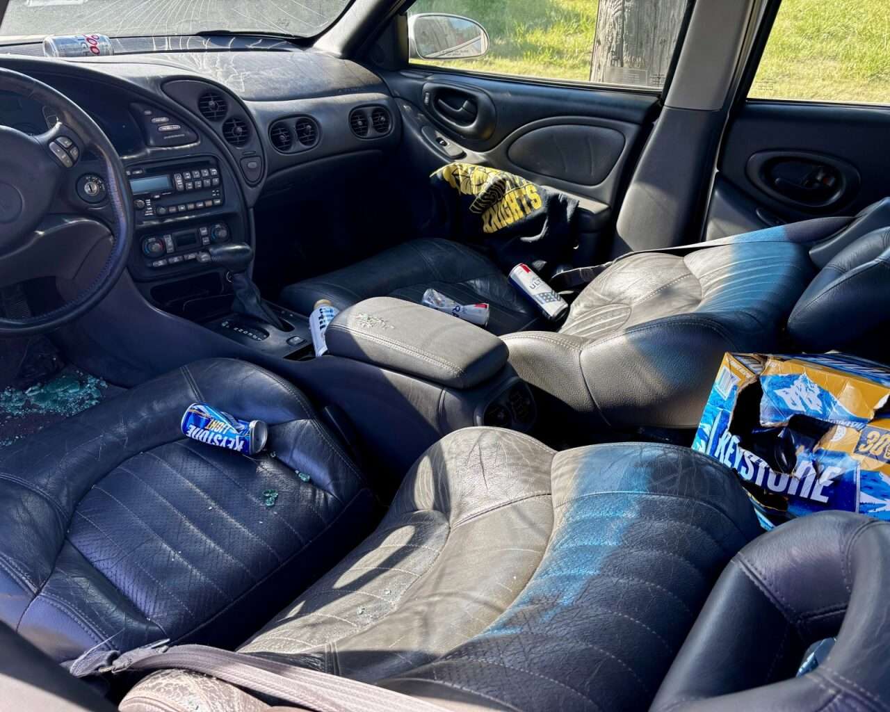 The inside of one of the two vehicles covered in broken glass and beer cans. This was the car that the dead role-playing victim was pulled from. Photo by Tony Guerrero/Hays Post