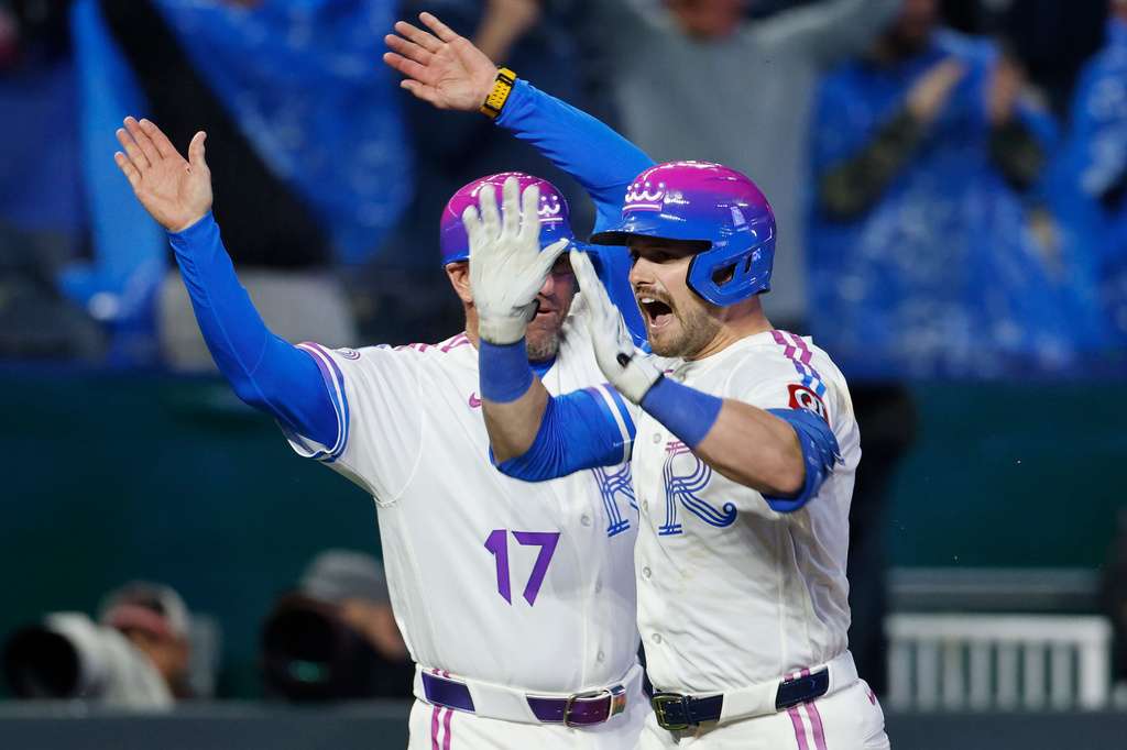 Umpire Alan Porter, center, calls for a rain delay as Los Angeles Angels players and members of the Kansas City Royals grounds crew stand on the pitchers mound during the seventh inning of a baseball game in Kansas City, Mo., Sunday, April 26, 2026. (AP Photo/Colin E. Braley)