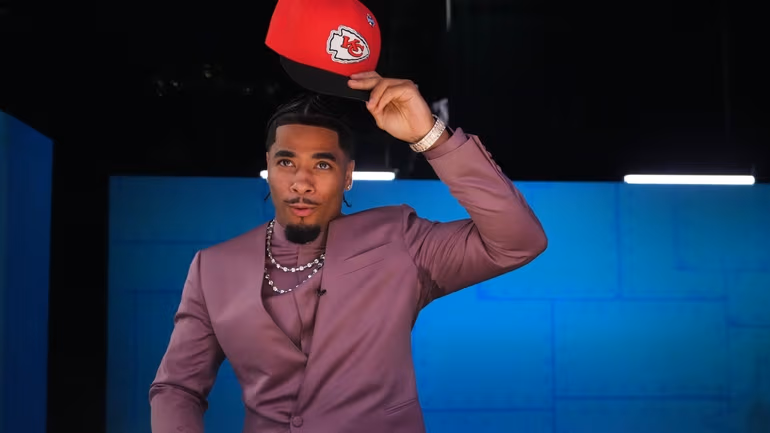 LSU defensive back Mansoor Delane puts on a hat after being chosen by the Kansas City Chiefs with the sixth overall pick during the first round of the NFL football draft, Thursday, April 23, 2026, in Pittsburgh. (AP Photo/Jeff Roberson)