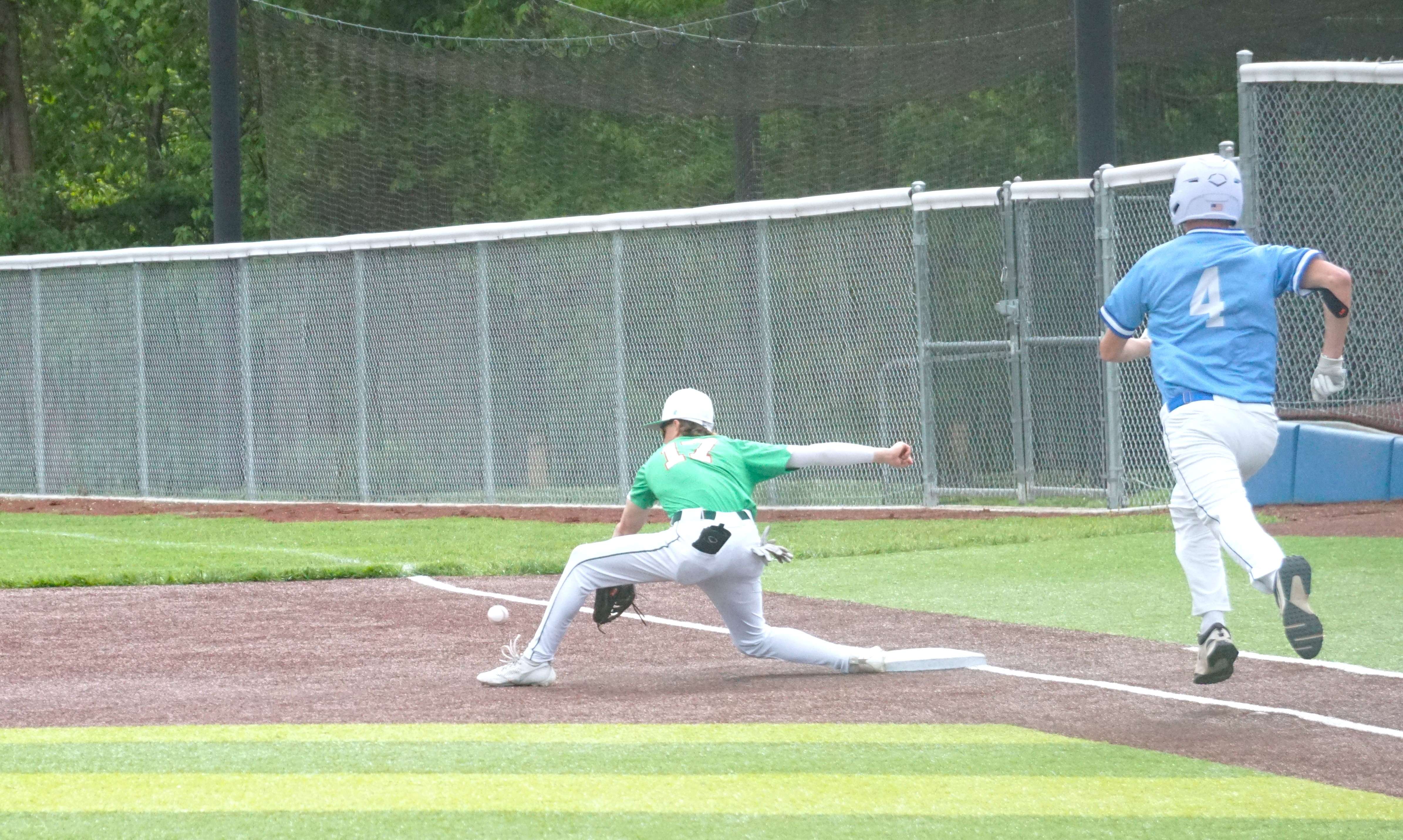 Mid-Buchanan first baseman Mason Partridge (17) makes a pick play as West Platte's Mathew Cook (4) runs down the line./ Photo by Matt Pike