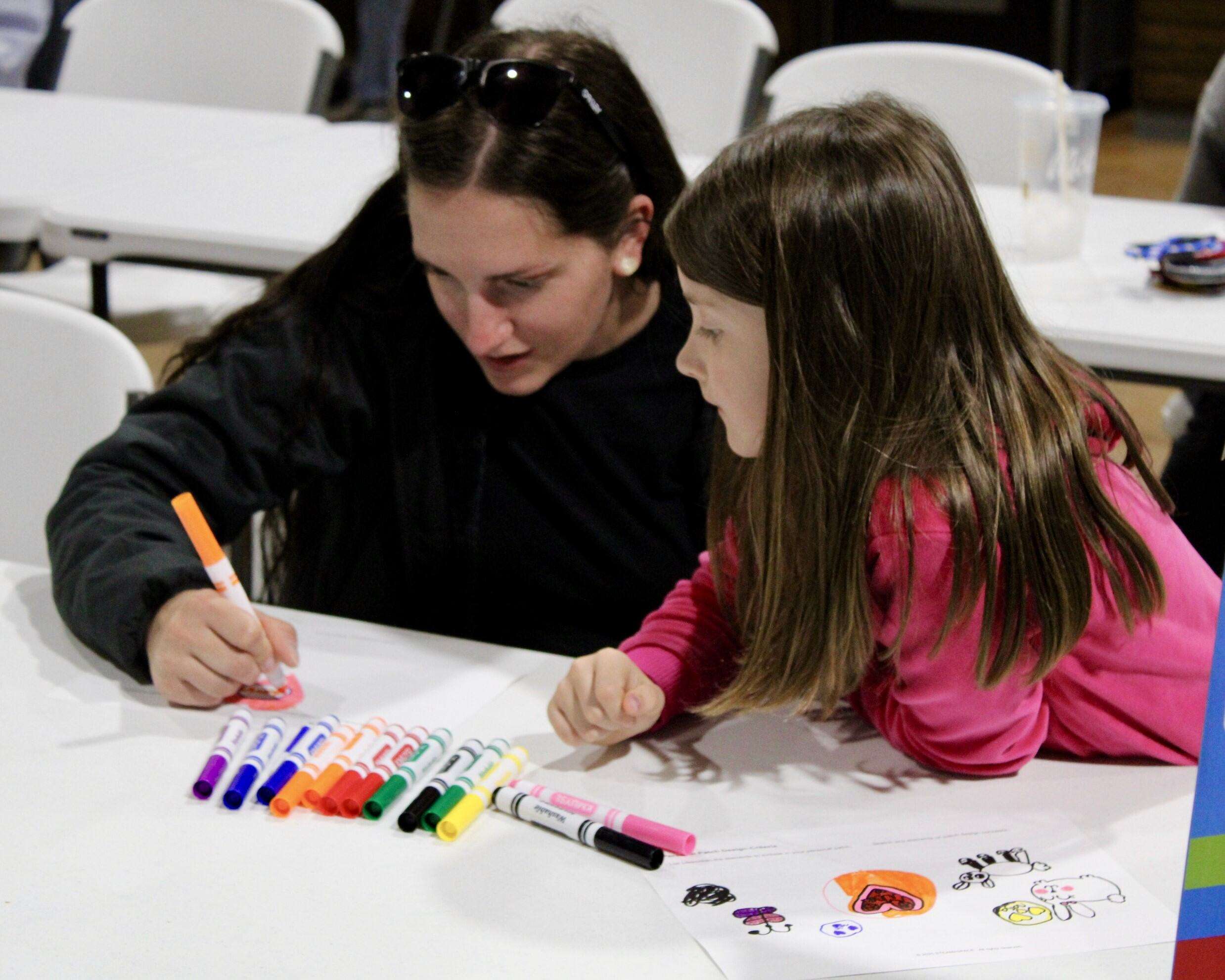 Attendees drawing their own mission patches at the exclusive "Adventure in Space" event at STEM Harvest. Photo by Tony Guerrero/Hays Post