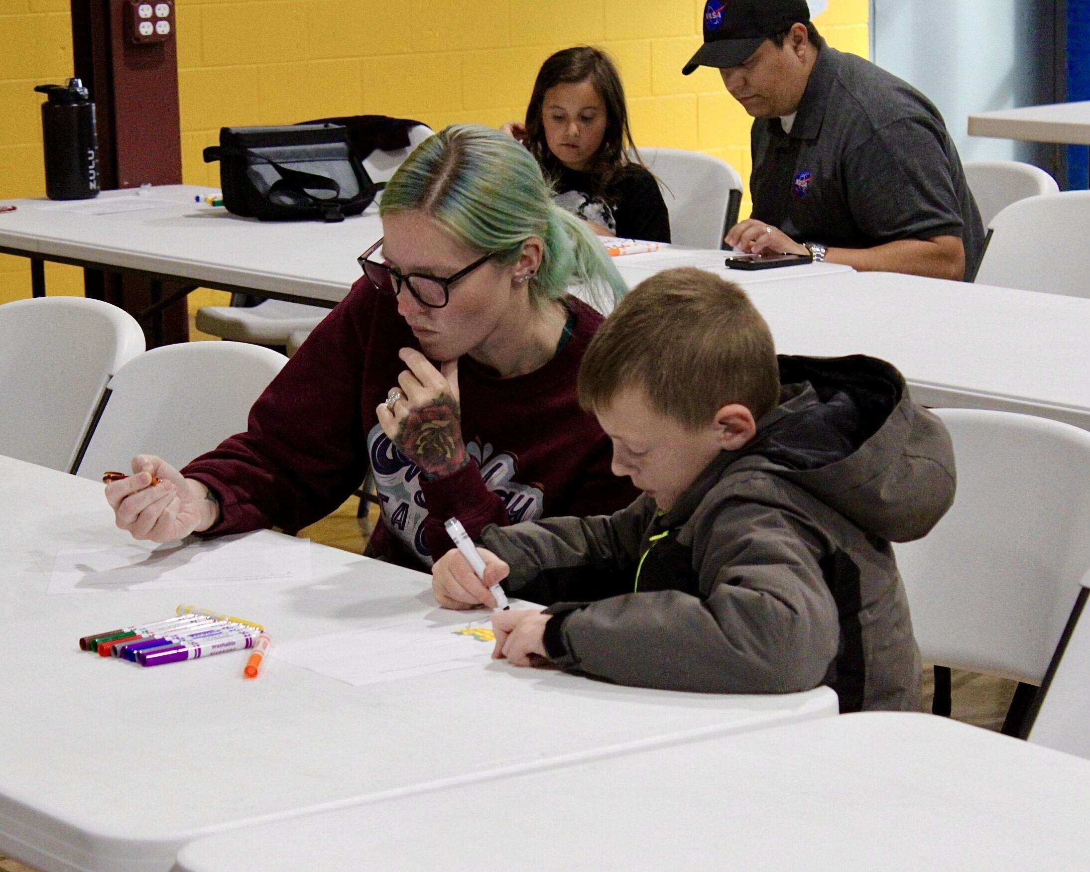 Attendees drawing their own mission patches at the exclusive "Adventure in Space" event at STEM Harvest. Photo by Tony Guerrero/Hays Post