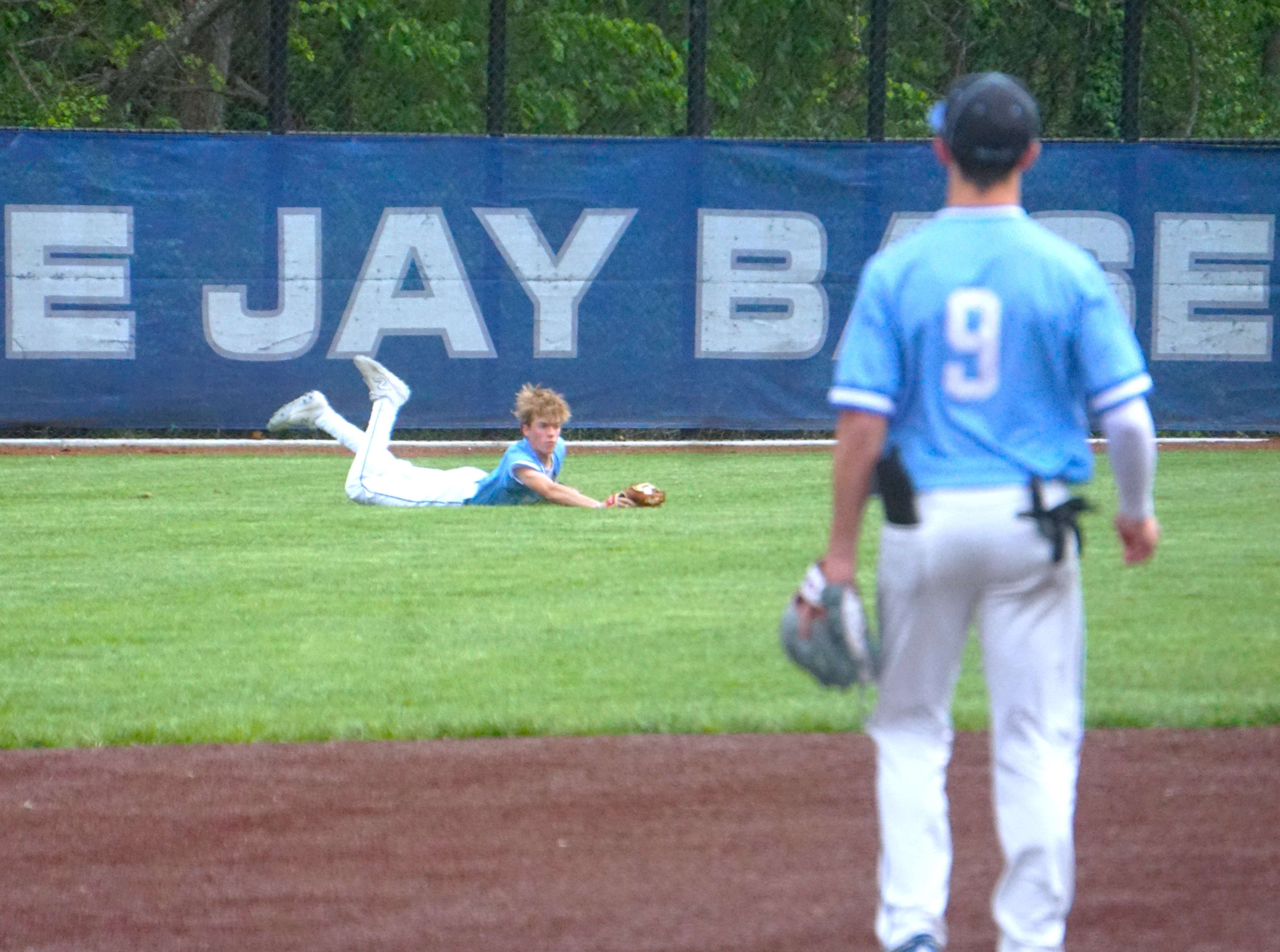 West Platte left fielder Boyd Leininger makes a diving catch against Mid-Buchanan/ Photo by Matt Pike