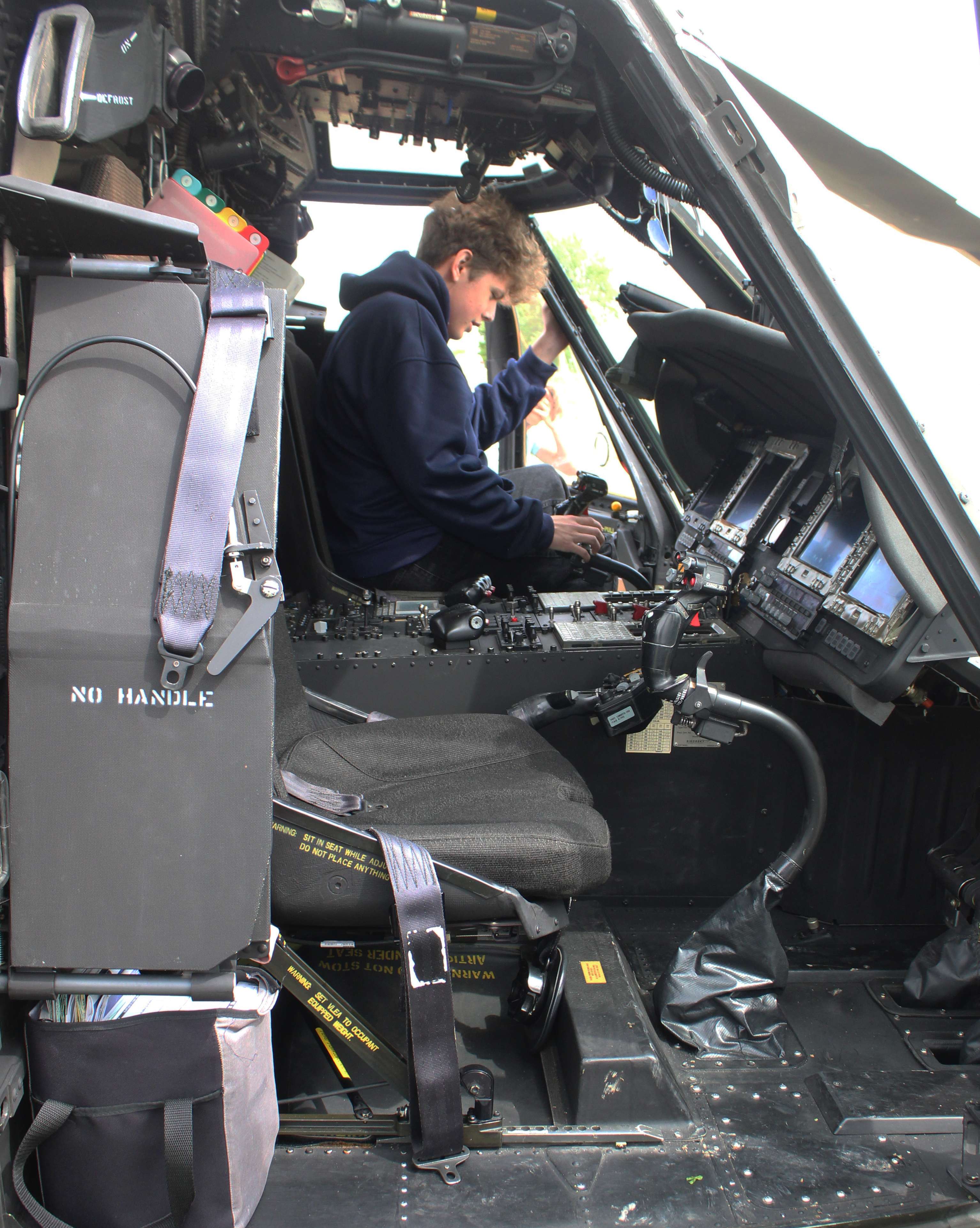 A student explores the cockpit of one of the Kansas National Guard Blackhawk helicopters on Wednesday.&nbsp;Photo by Cristina Janney/Hays Post