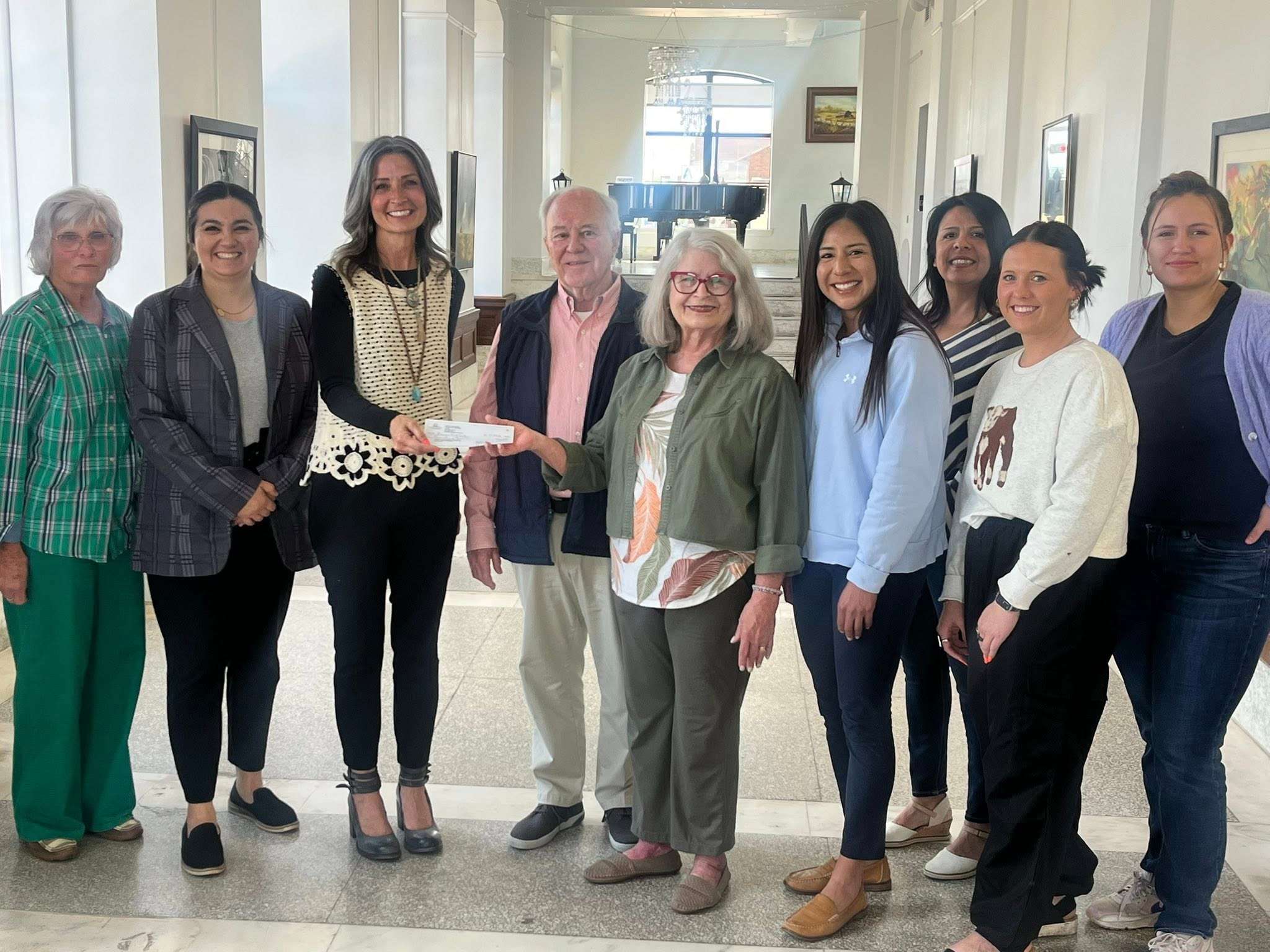 $10,000 Giving Day Gift to the Prairie Arts Center in memory of Erika Schmidt. Volunteer Barbara Planansky, Board President Kendall King, Exec Dir Holly Carlini, Ken Anderson, Carolyn Anderson, V. Pres. Marissa Ramos, Board Memenr Jessica Lawrence, Events Coor Janee” Elfeldt and creative Assoc Chloe Bearkiller