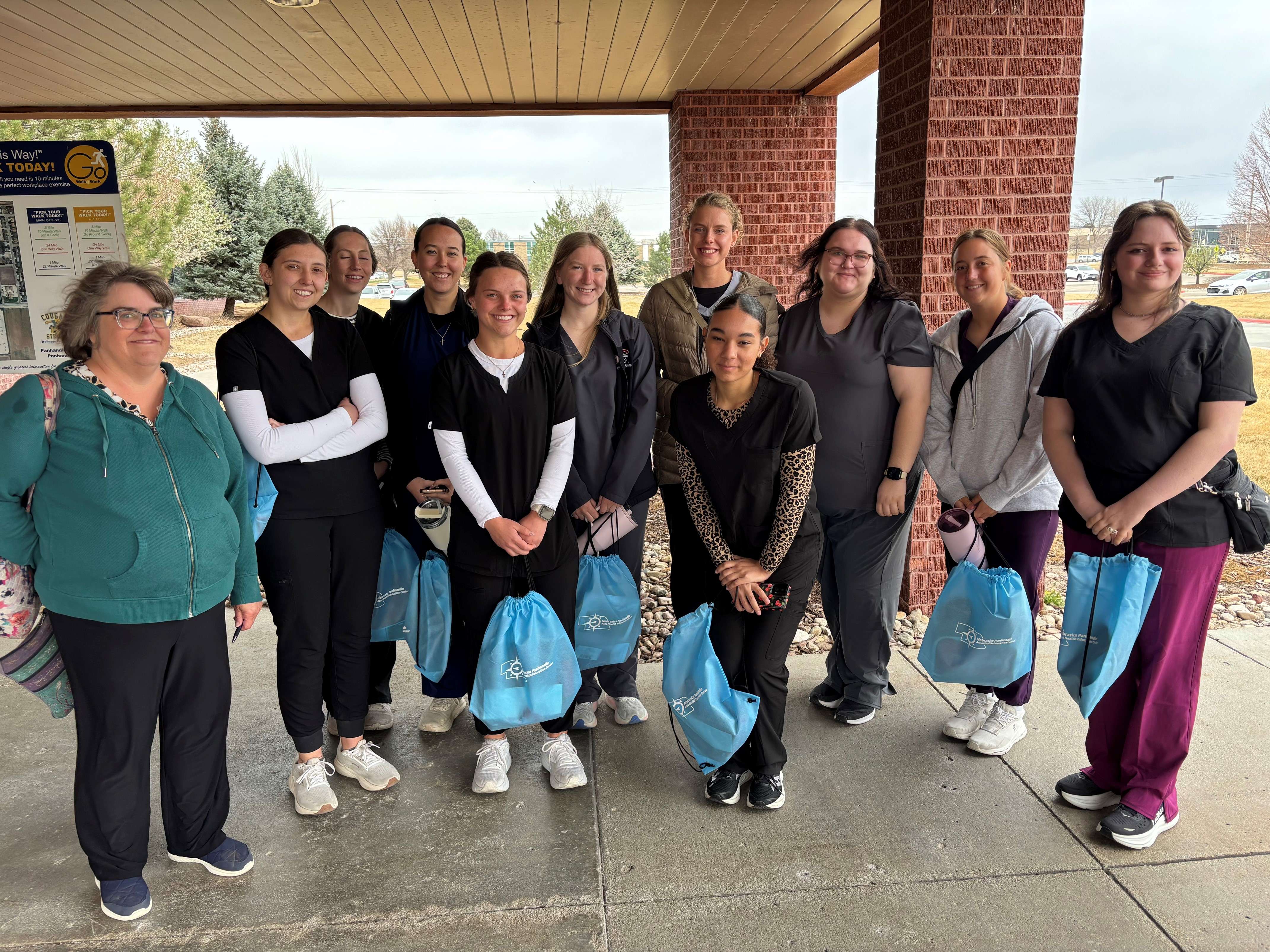A group of Chadron State College pre-nursing students pose with Dr. Ann Buchmann, left, in Scottsbluff, Neb., in late March 2026. From left, Kylee Simon, Janie Davis, Carlie Schneider, Shaylee Thomsen, Emma Carfield, Hannah Haertel, Maleah Ruff, Jaylee McCloud, McKenna Sides, Katie Hoevet. (Courtesy photo, used with permission)