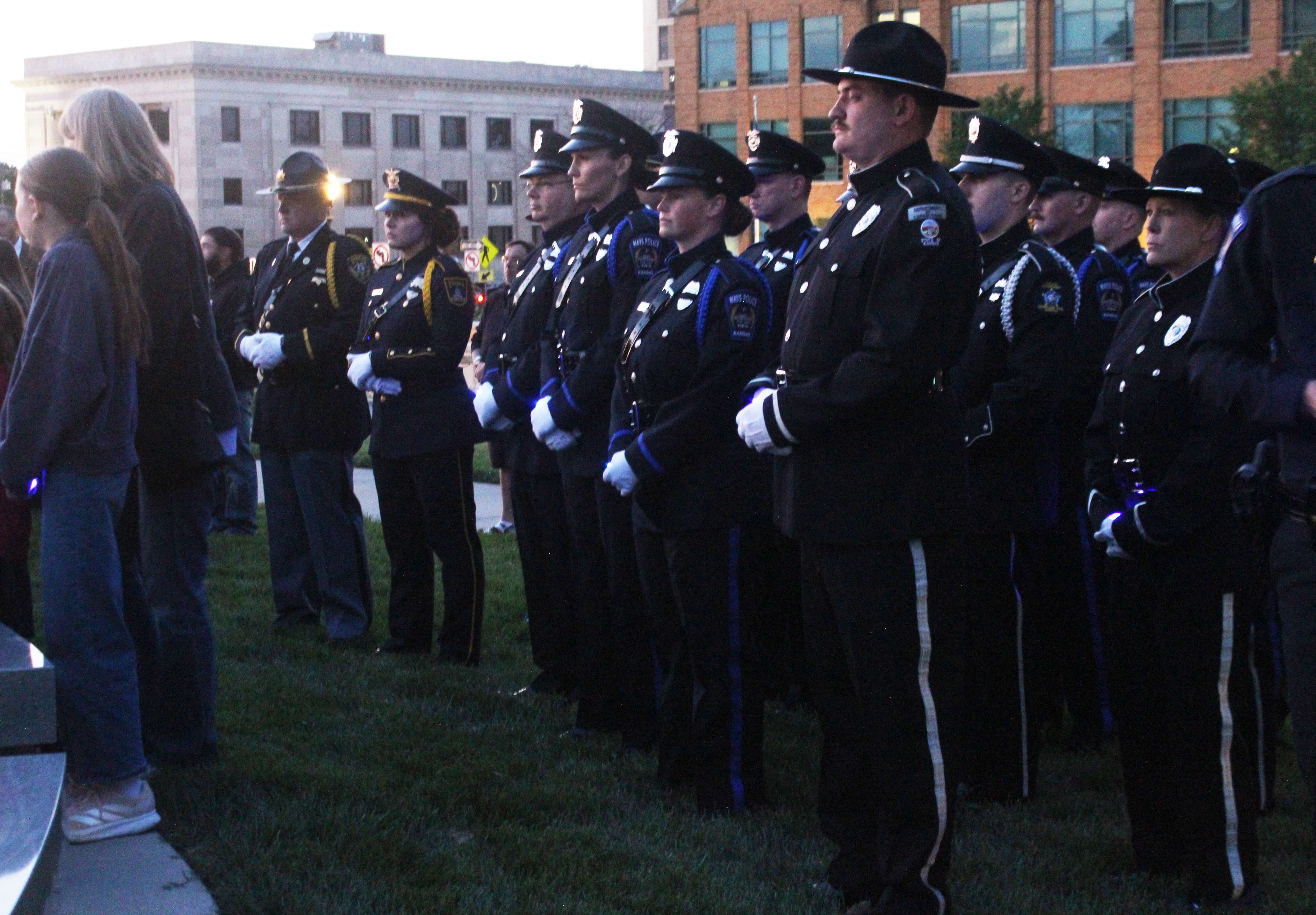 Officers, including members of the Hays Police Department, participate in a vigil at the Kansas Fallen Law Enforcement Officer Memorial on Thursday.&nbsp;Photo by Cristina Janney/Hays Post
