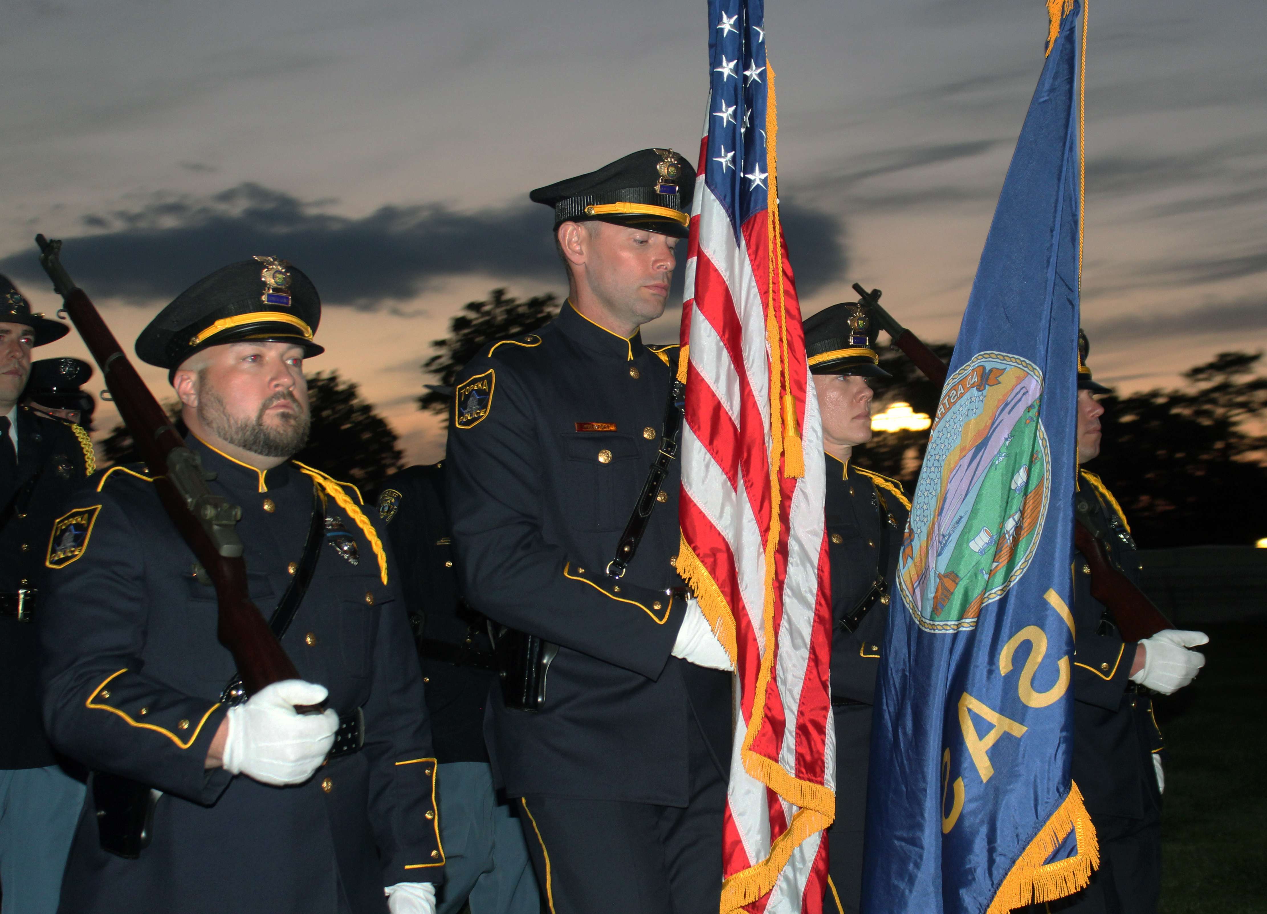 Members of an honor guard lead a procession as part of a candlelight vigil for fallen law enfrocement officers at the Capitol on Thursday.&nbsp;Photo by Cristina Janney/Hays Post