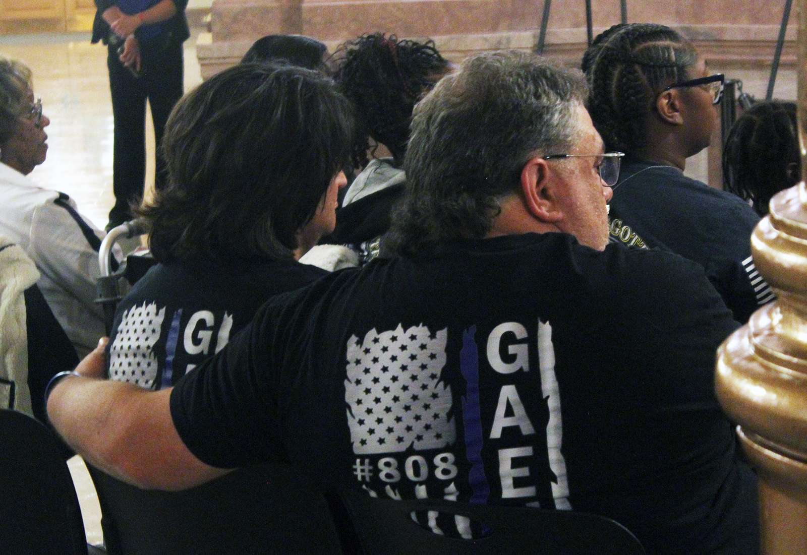 Philips County Undersheriff Brandon Gaede's father and stepmother listen to tributes to fallen officers during a ceremony at the Capitol on Thursday.&nbsp;Photo by Cristina Janney/Hays Post