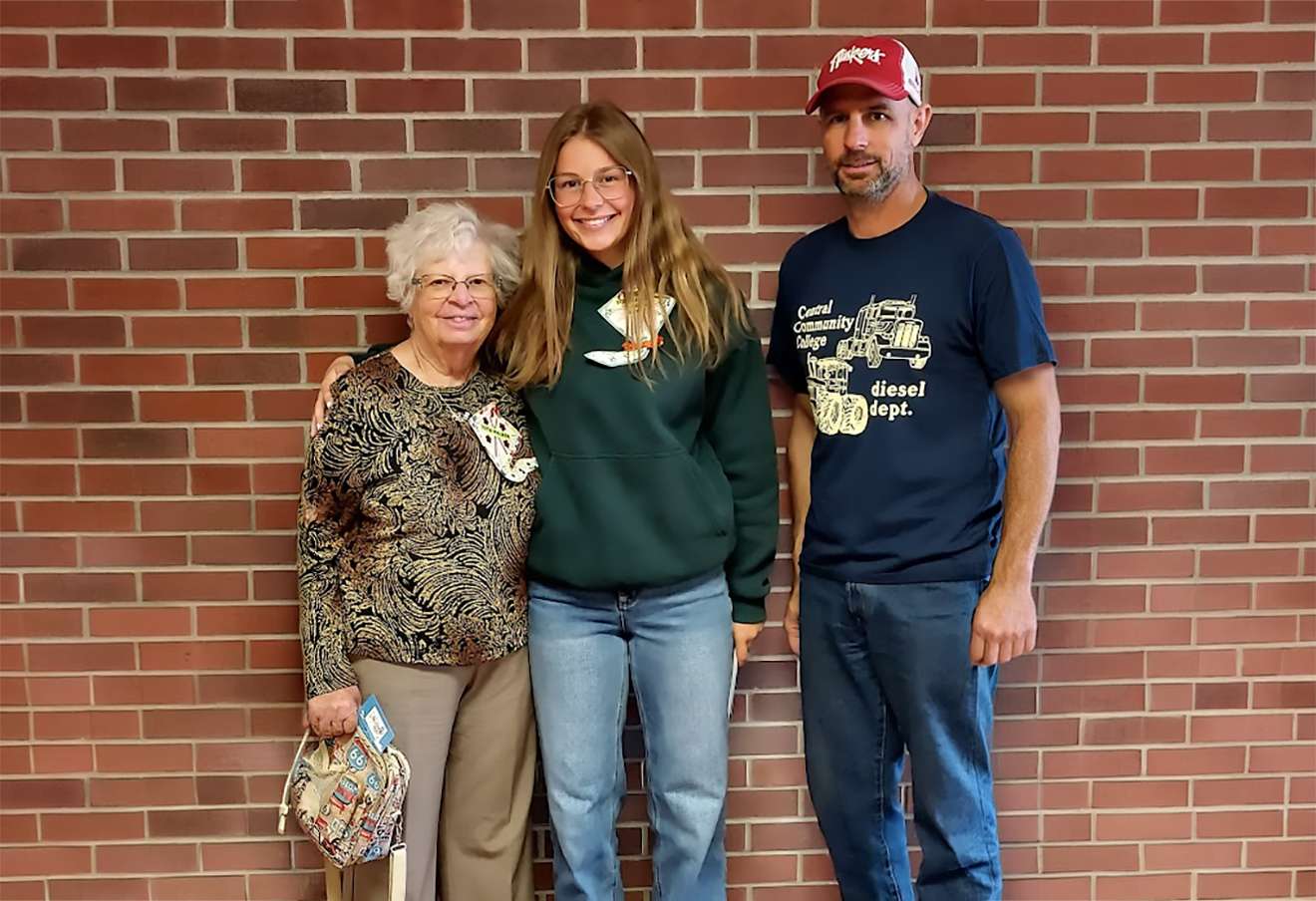 A scholarship winner, Katelyn Walker, stands next to her grandmother and Homemaker member Ruth Walker, left, with her dad, Chauncey Walker. Her mother, Sarah Walker, is not pictured. Photo by Laurie Zitterkopf