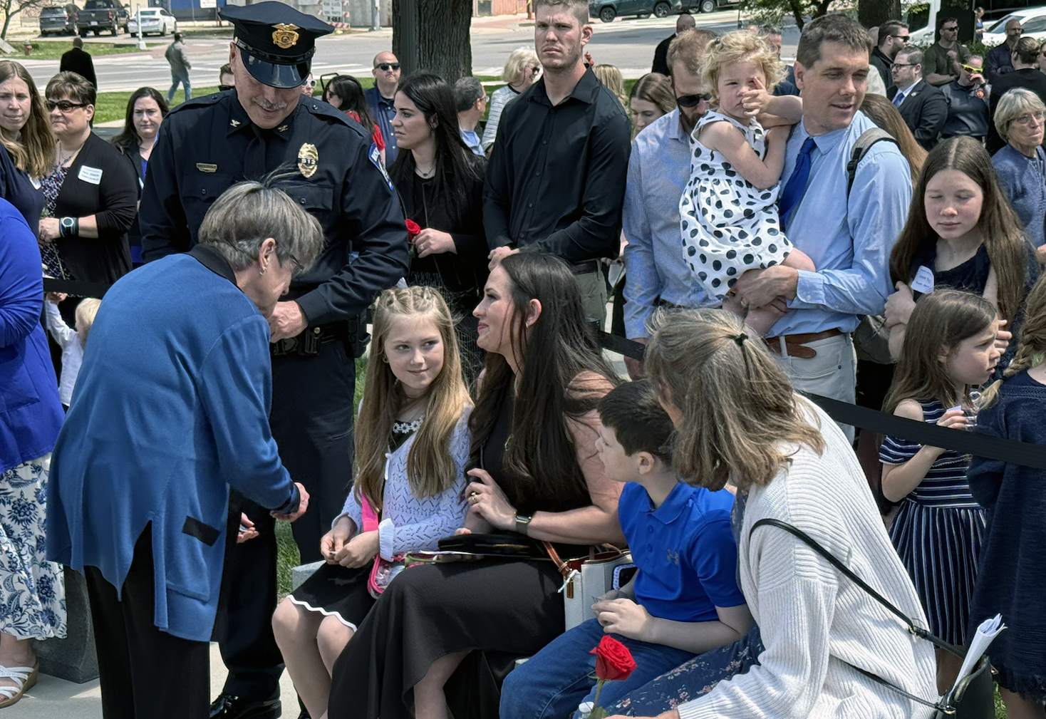 Gov. Laura Kelly greets Sgt. Scott's Heimann's widow, Beth, children and mother as Hays Police Chief Don Scheibler looks on, standing left. Heimann's name was dedicated at the annual Kansas Law Enforcement Memorial on Friday at the Capitol grounds. Photo by Cristina Janney/Hays Post
