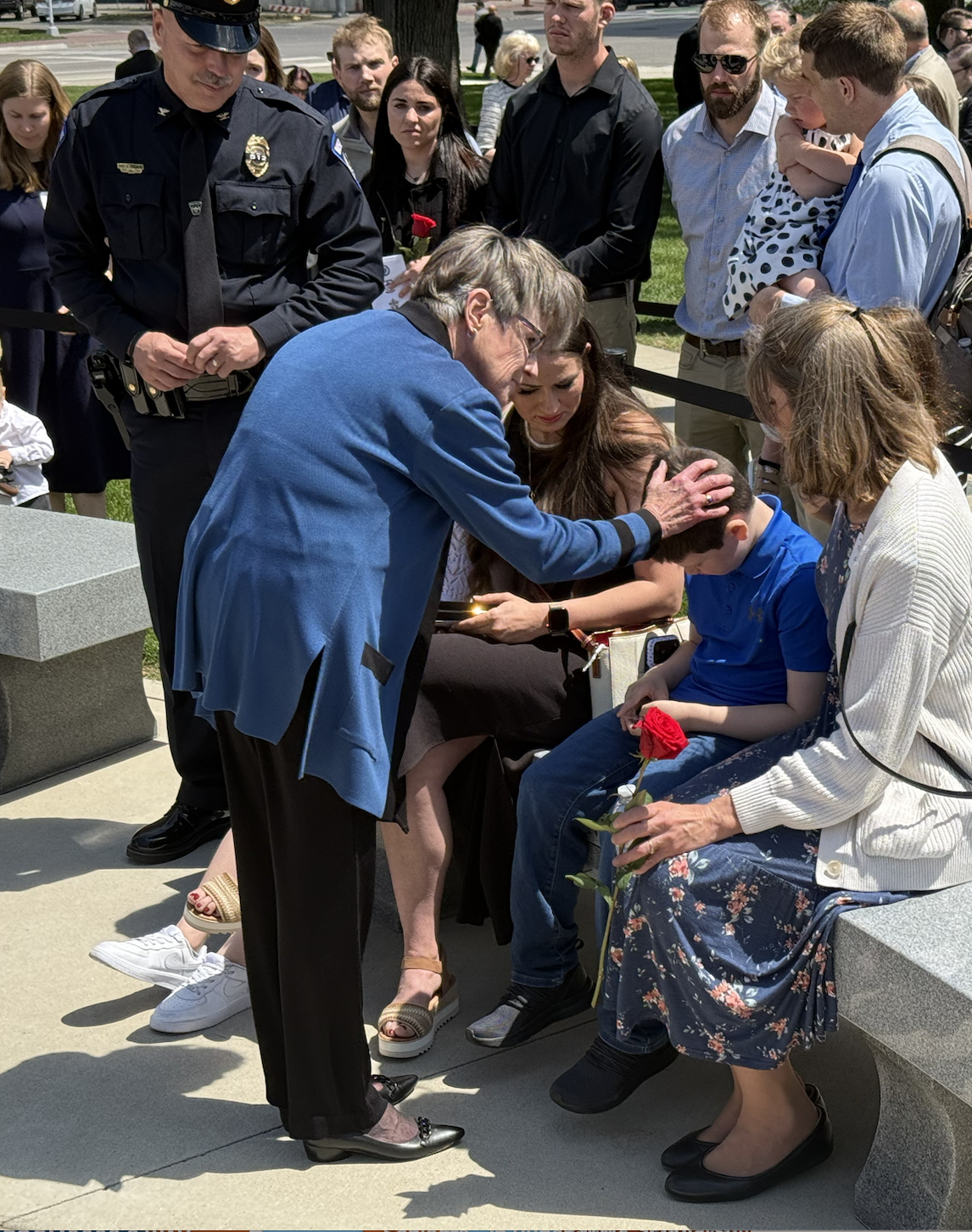 Governor Laura Kelly comforts Hays Police Sgt. Scott Heimann's son Friday during a ceremony Friday at the Kansas Law Enforcement Memorial. Heimann was killed on Sept. 28 when responding to a barricaded suspect in Hays.&nbsp;Photo by Cristina Janney/Hays Post