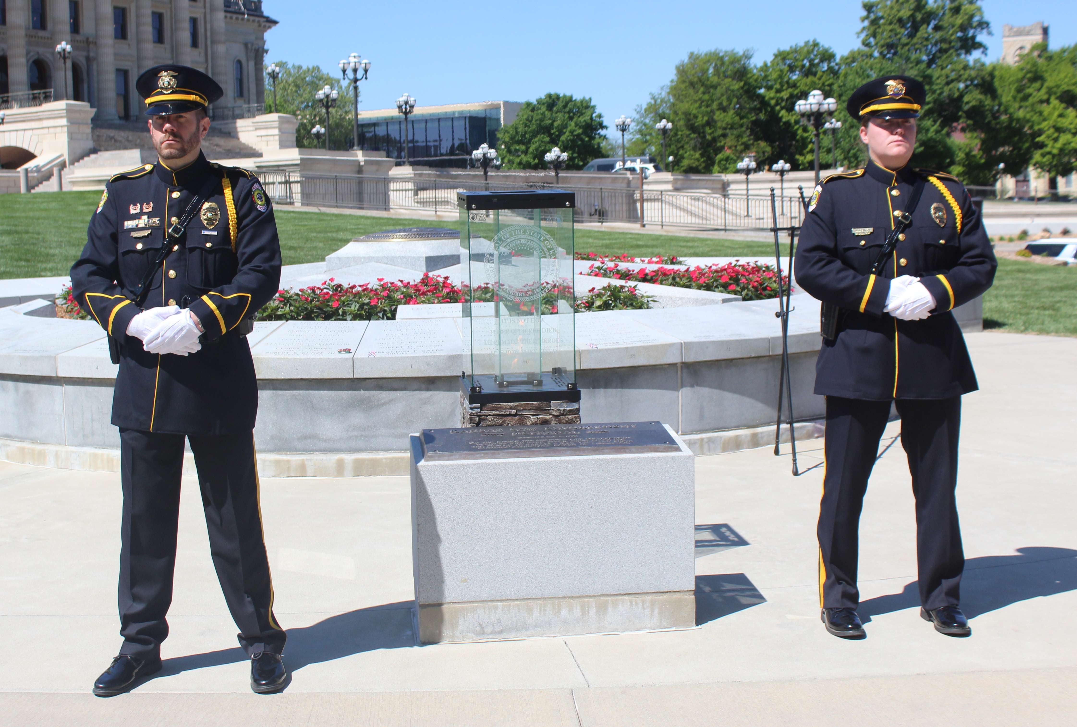 Two officers stand watch at the Kansas Law Enforcement Memorial on Friday on the Capitol grounds.&nbsp;Photo by Cristina Janney/Hays Post
