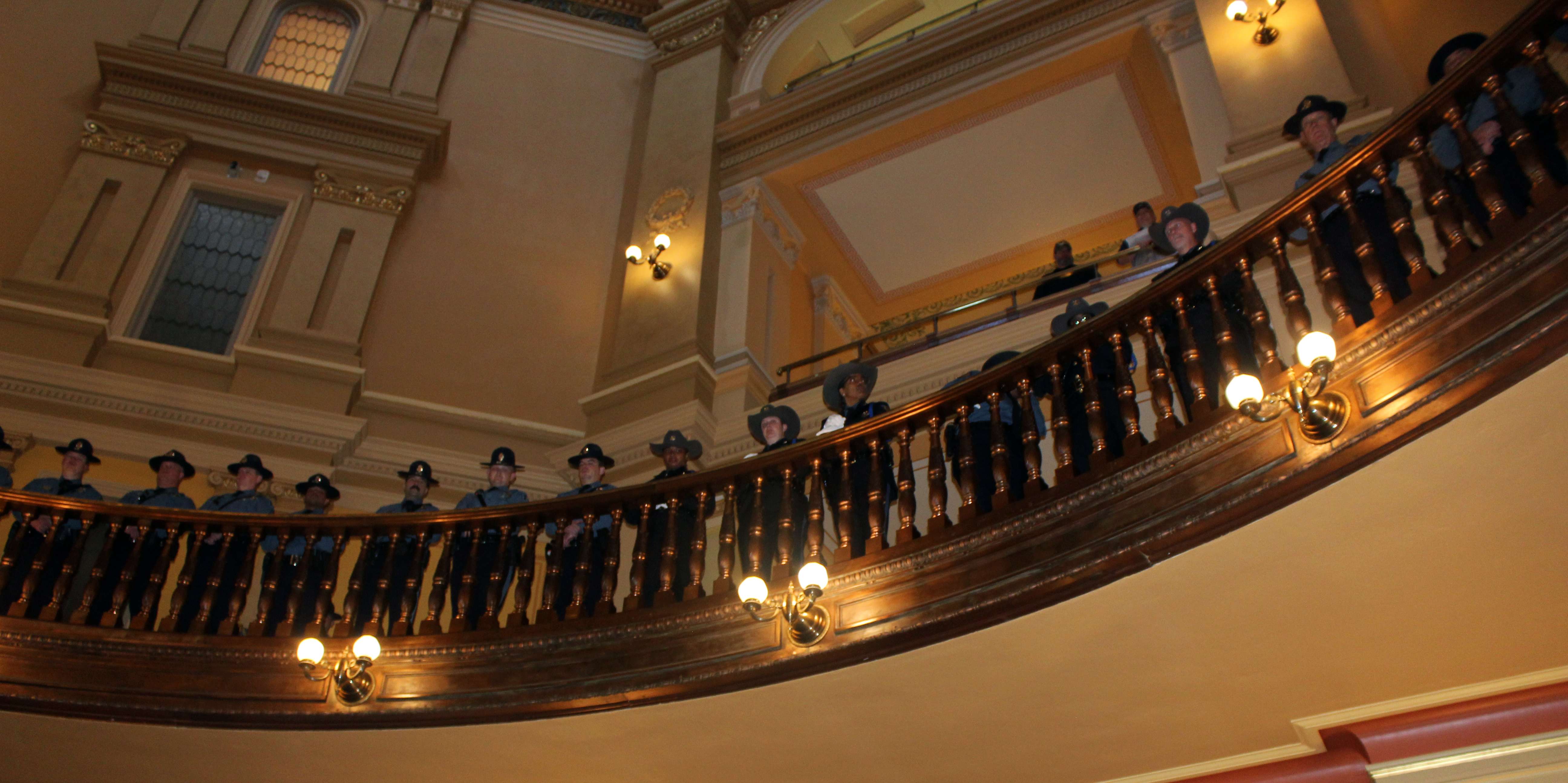 Officers stand at attention in the upper levels of the rotunda during ceremonies&nbsp;on Friday in Topeka.