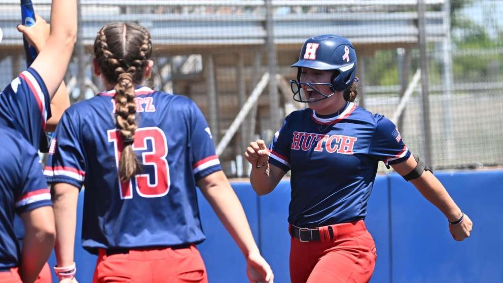 Sophomore center fielder Kaibryn Kruger is about to celebrate with teammates after hitting a game-tying two-run home run the bottom of the first inning of Game 1 of a 5-3 Blue Dragon victory over Cloud County on Saturday at Fun Valley. (Andrew Carpenter/Digital Fox Photography).
